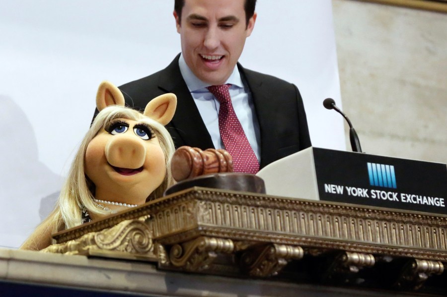 FILE - Miss Piggy, with New York Stock Exchange Chief of Staff John Tuttle, rings the NYSE opening bell to highlight the season premier of Disney's "The Muppets" television show, Feb. 1, 2016. (AP Photo/Richard Drew, File)