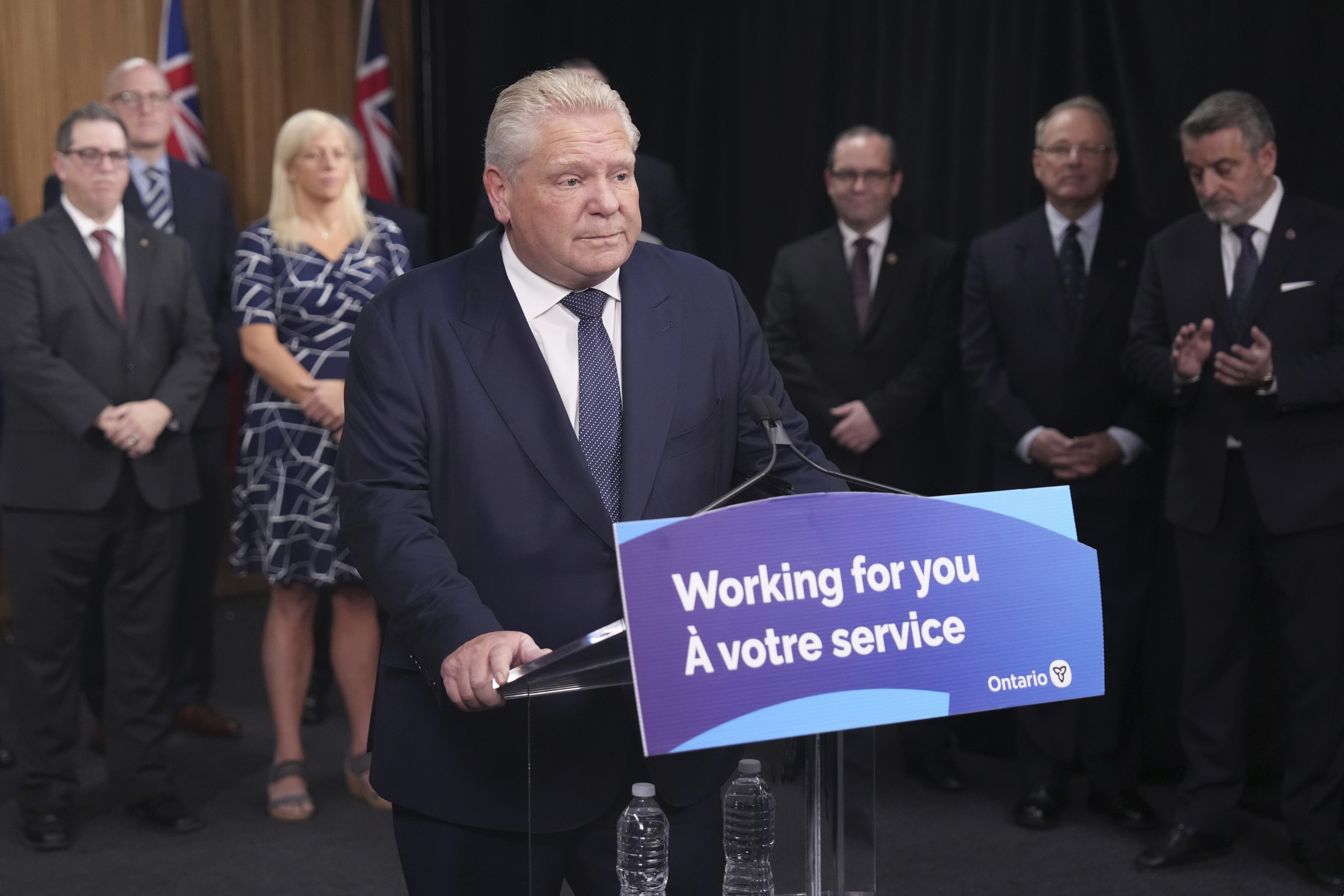 Ontario Premier Doug Ford speaks to members of the media as mayors from selected municipalities and government ministers look on the Queen's Park Legislature in Toronto on Thursday Dec. 12, 2024. (Chris Young/The Canadian Press via AP)