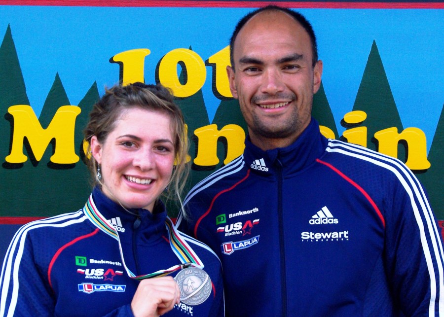 In this 2009 photo provided by Karen Gorman, biathlete Grace Boutot, left, of Fort Kent, Maine, displays her silver medal from the Youth Women Biathlon World Championships, while standing with coach Gary Colliander, right, in Fort Kent. (Karen Gorman via AP)