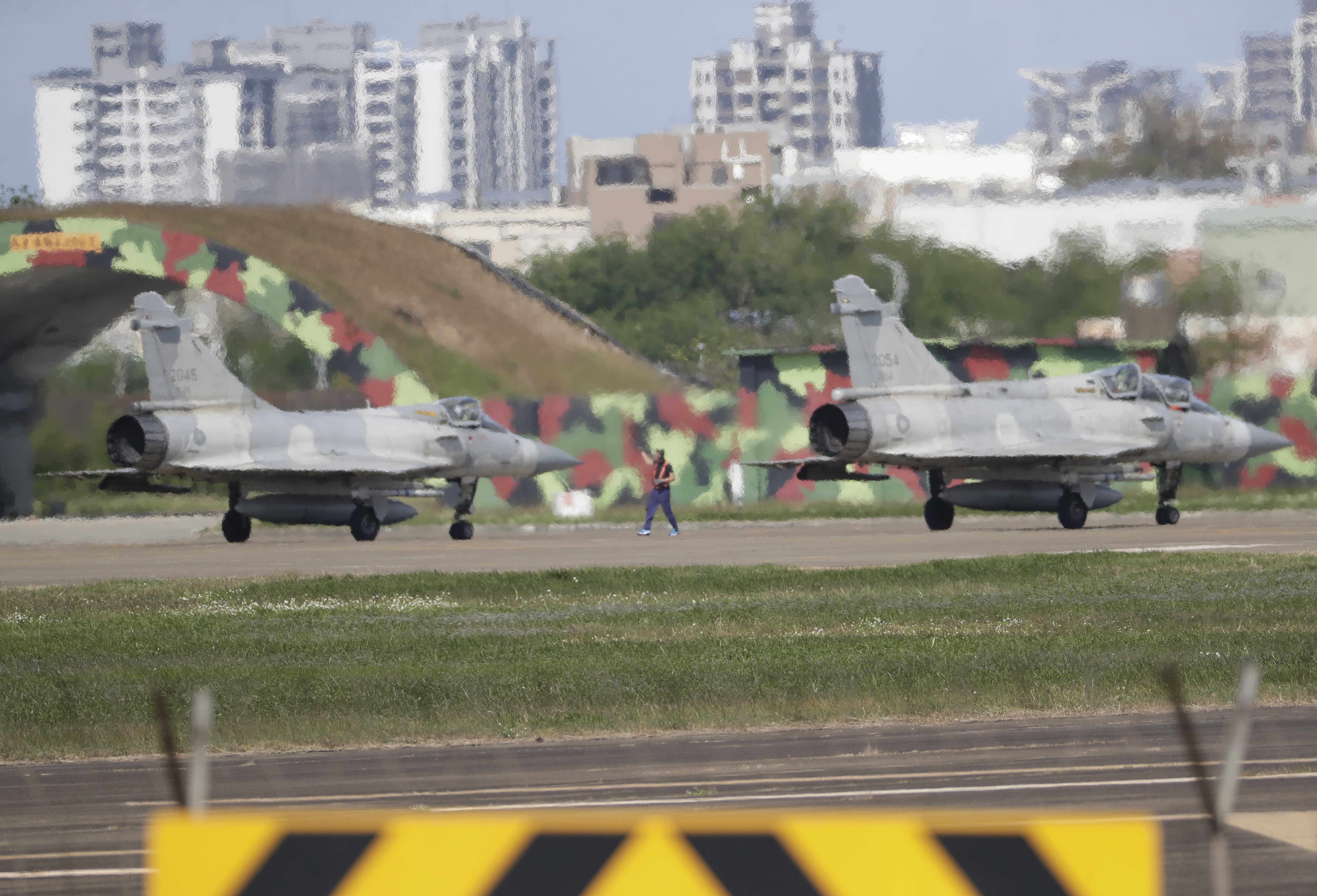 Taiwan's fighter jets prepare to take off at an airbase in Hsinchu, northern Taiwan, Wednesday, Dec. 11, 2024, as Taiwan's Defense Ministry said it detected Chinese naval ships and military planes engaged in training. (AP Photo/Chiang Ying-ying)