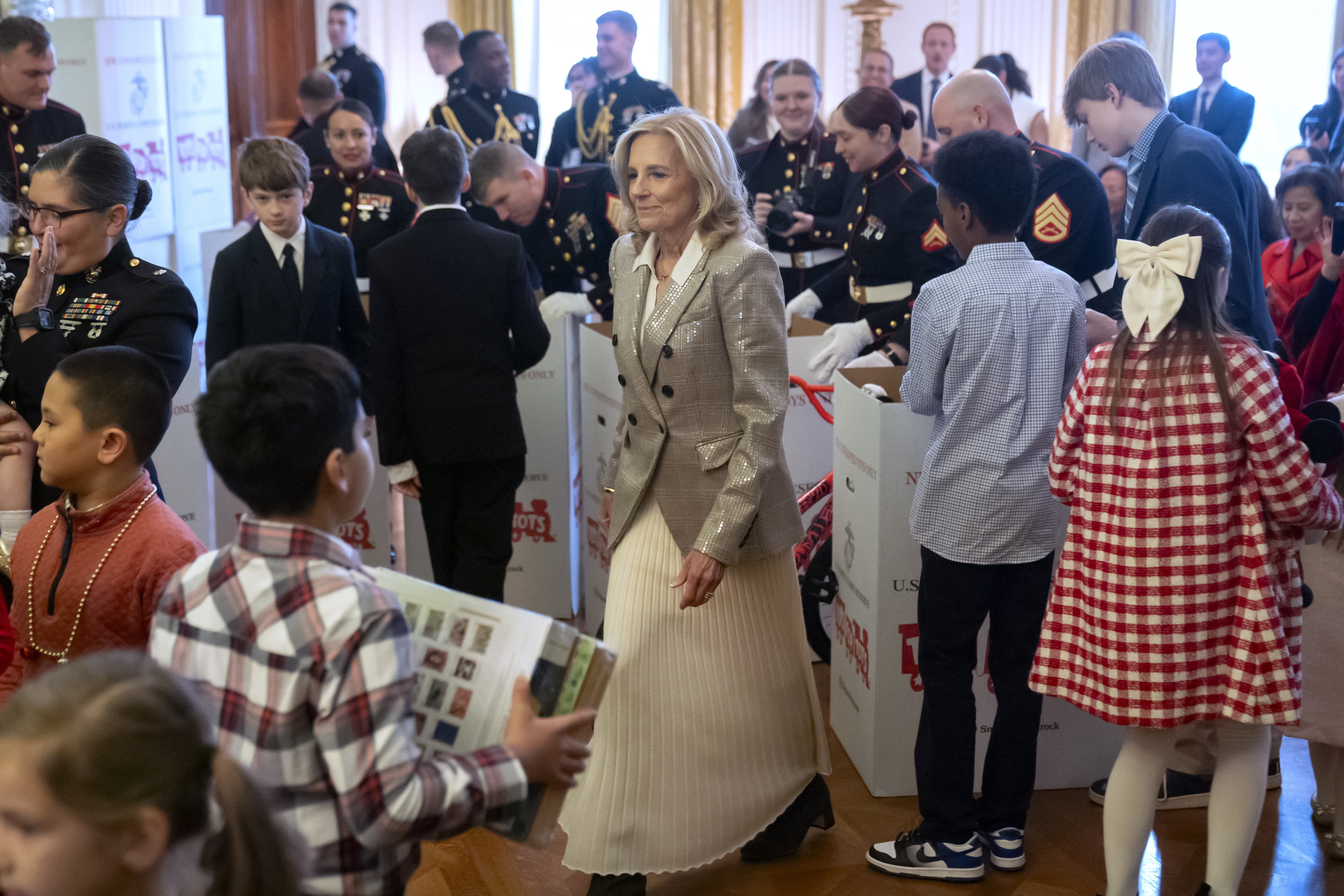 First lady Jill Biden sorts toys as she hosts a Toys for Tots event with Marine Corps families in the East Room at the White House in Washington, Friday, Dec. 13, 2024. (AP Photo/Mark Schiefelbein)