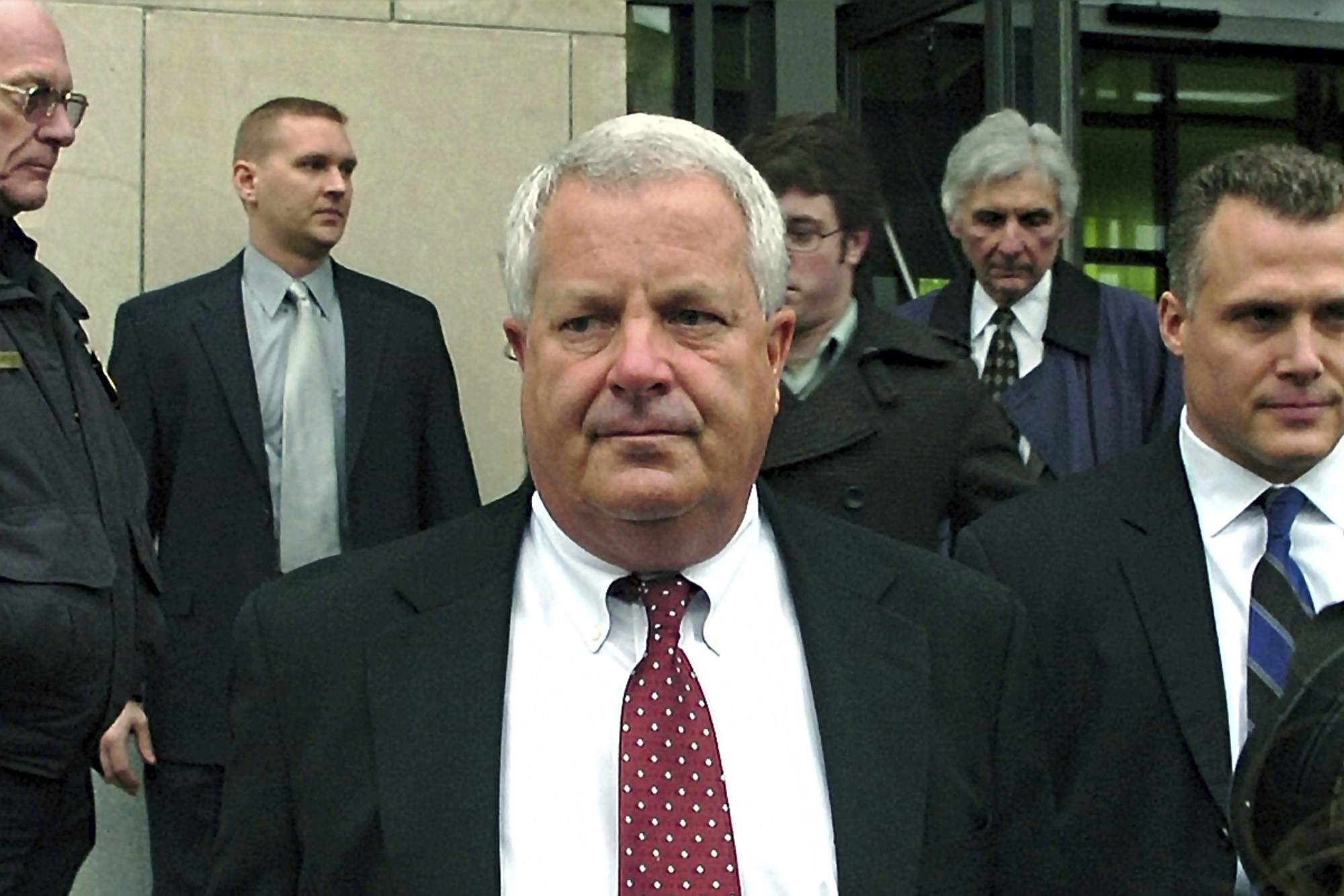 FILE - In this Feb. 12, 2009, file photo, Michael Conahan, center, a former Pennsylvania judge involved in a scheme to send youths to a for-profit jail in exchange for kickbacks, leaves the federal courthouse in Scranton, Pa. (AP Photo/David Kidwell, File)