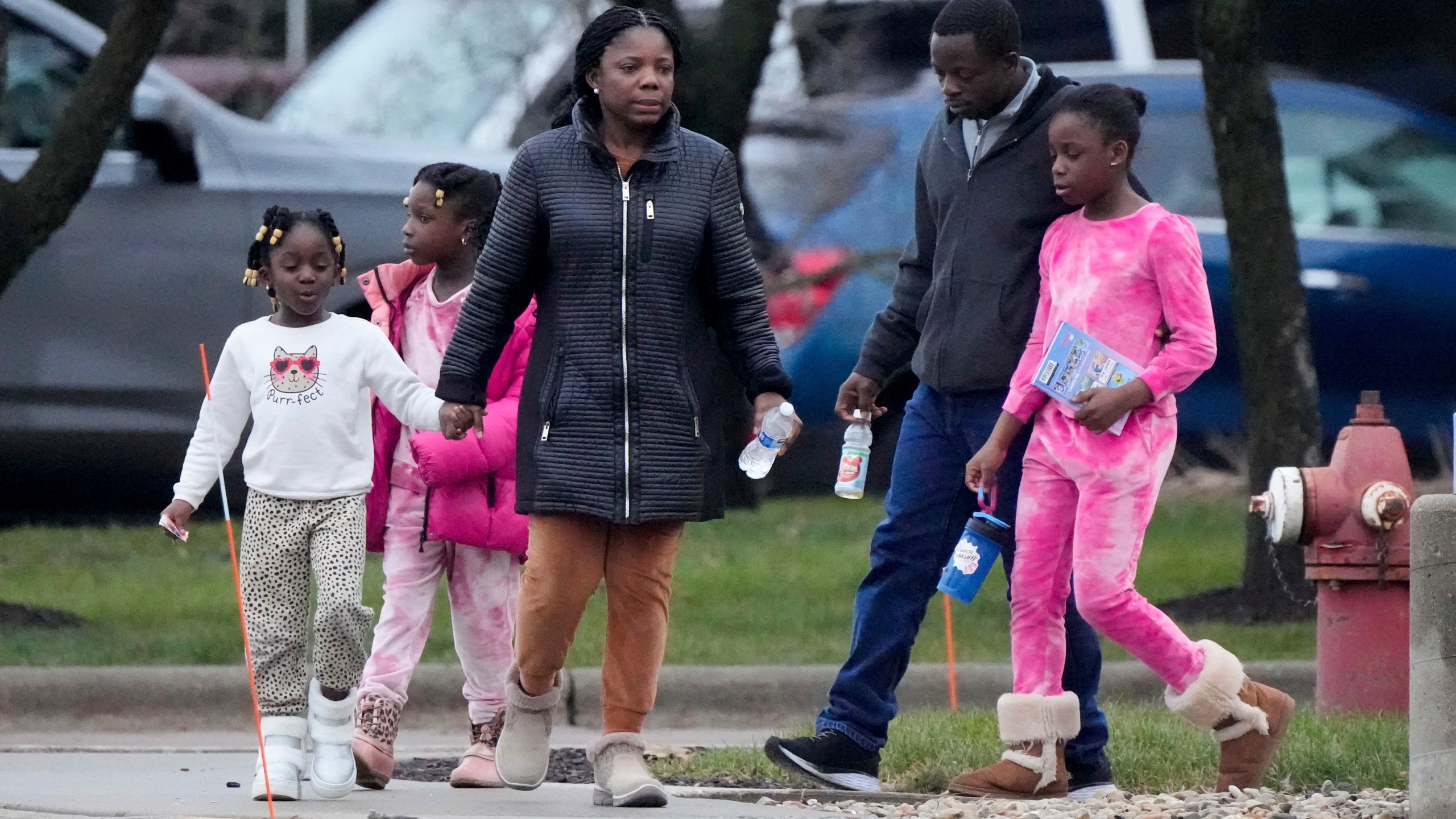 A family leaves the SSMI Health Center, set up as an reunification center, in Madison, Wis., following a shooting, Monday, Dec. 16, 2024. (AP Photo/Morry Gash)