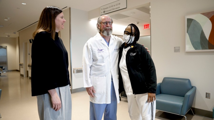 Pig kidney recipient Towana Looney stands with transplant surgeons Dr. Jayme Locke, left, now of the U.S. Health Resources & Services Administration and Dr. Robert Montgomery of NYU Langone Health, center, on Dec. 10, 2024, at NYU Langone Health, in New York City. (AP Photo/Shelby Lum)