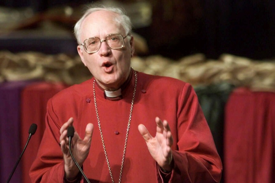 FILE - The Archbishop of Canterbury George Carey leads a morning worship service at the United Methodist Church General Conference in Cleveland on May 10, 2000. (AP Photo/Mark Duncan, File)