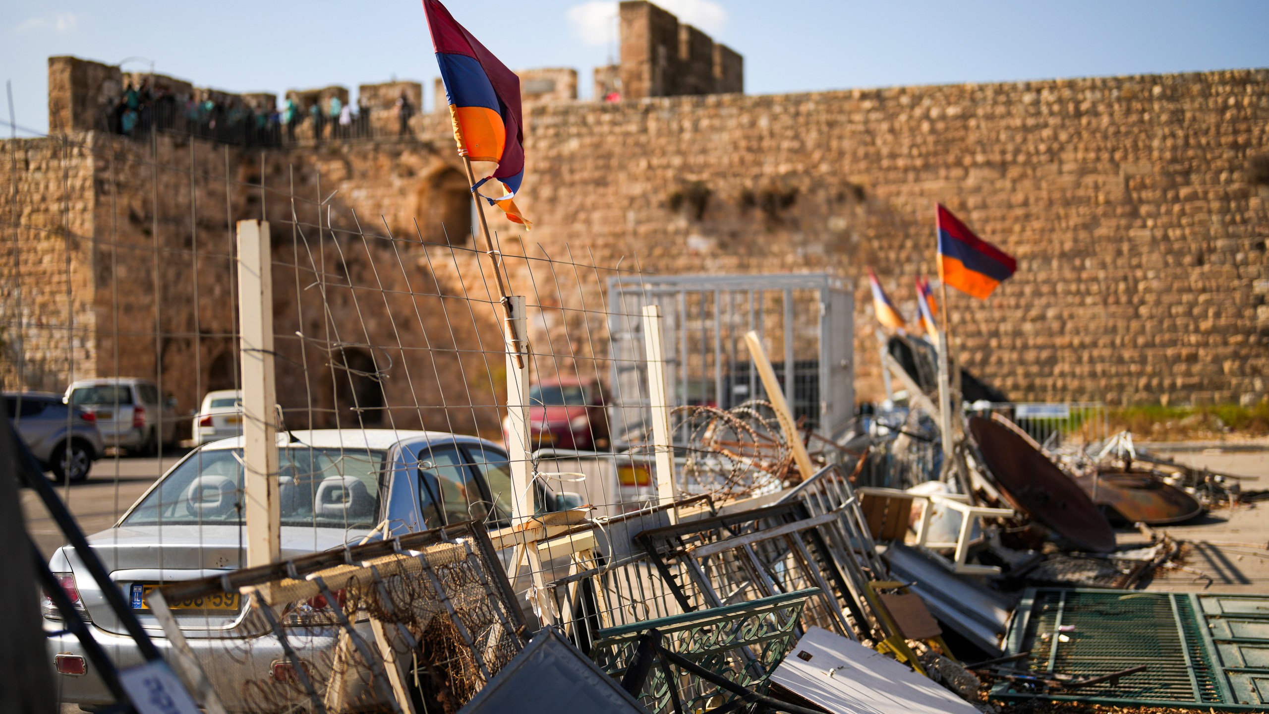 Armenian flags wave in a makeshift barricade set up by local activists in a parking area known as "Cows garden" at the Armenian quarter in Jerusalem, Thursday, Nov. 21, 2024. (AP Photo/Francisco Seco)