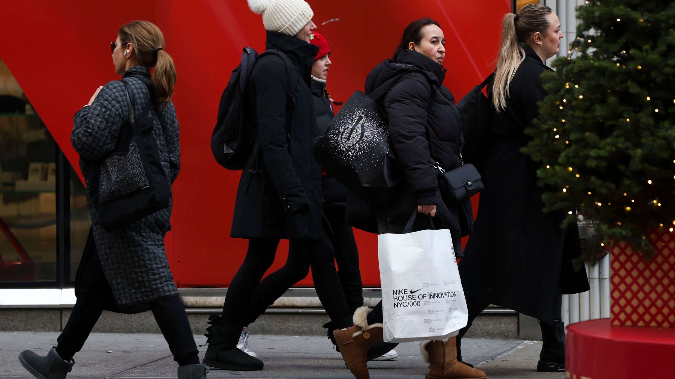 FILE - Shoppers walk along Fifth Avenue on Nov. 29, 2024, in New York. (AP Photo/Heather Khalifa, File)