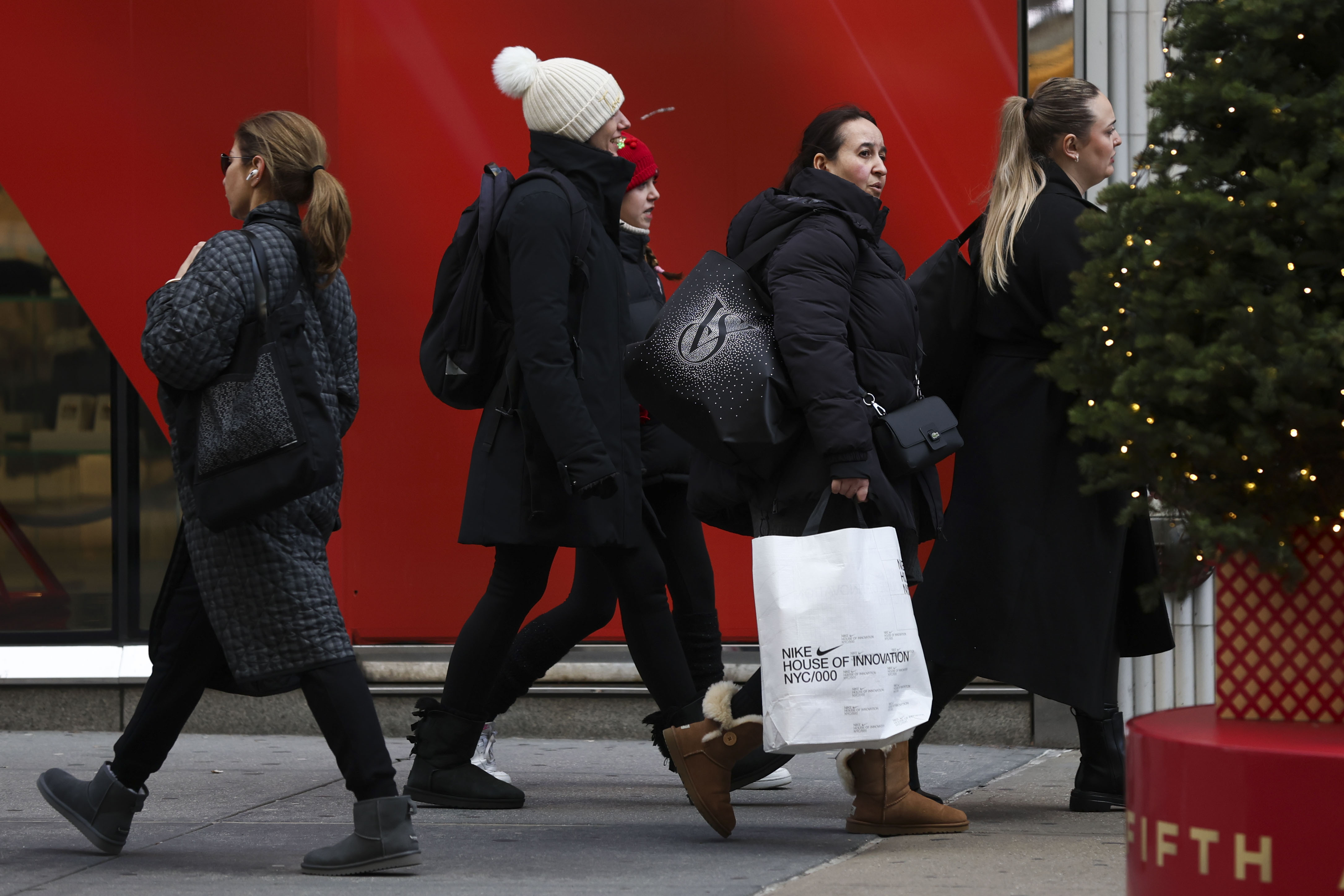 FILE - Shoppers walk along Fifth Avenue on Nov. 29, 2024, in New York. (AP Photo/Heather Khalifa, File)