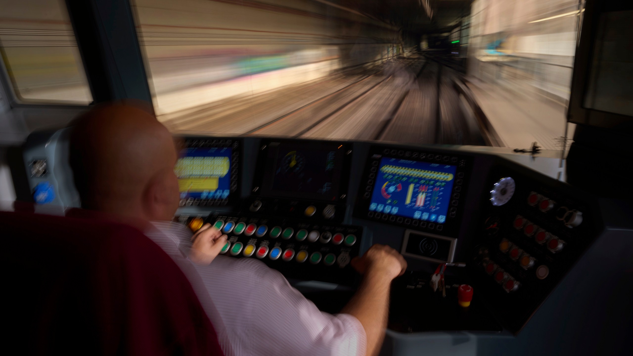 A subway driver operates the train's brake lever before entering a station in Barcelona, Spain, Monday, Dec. 2, 2024. (AP Photo/Emilio Morenatti)