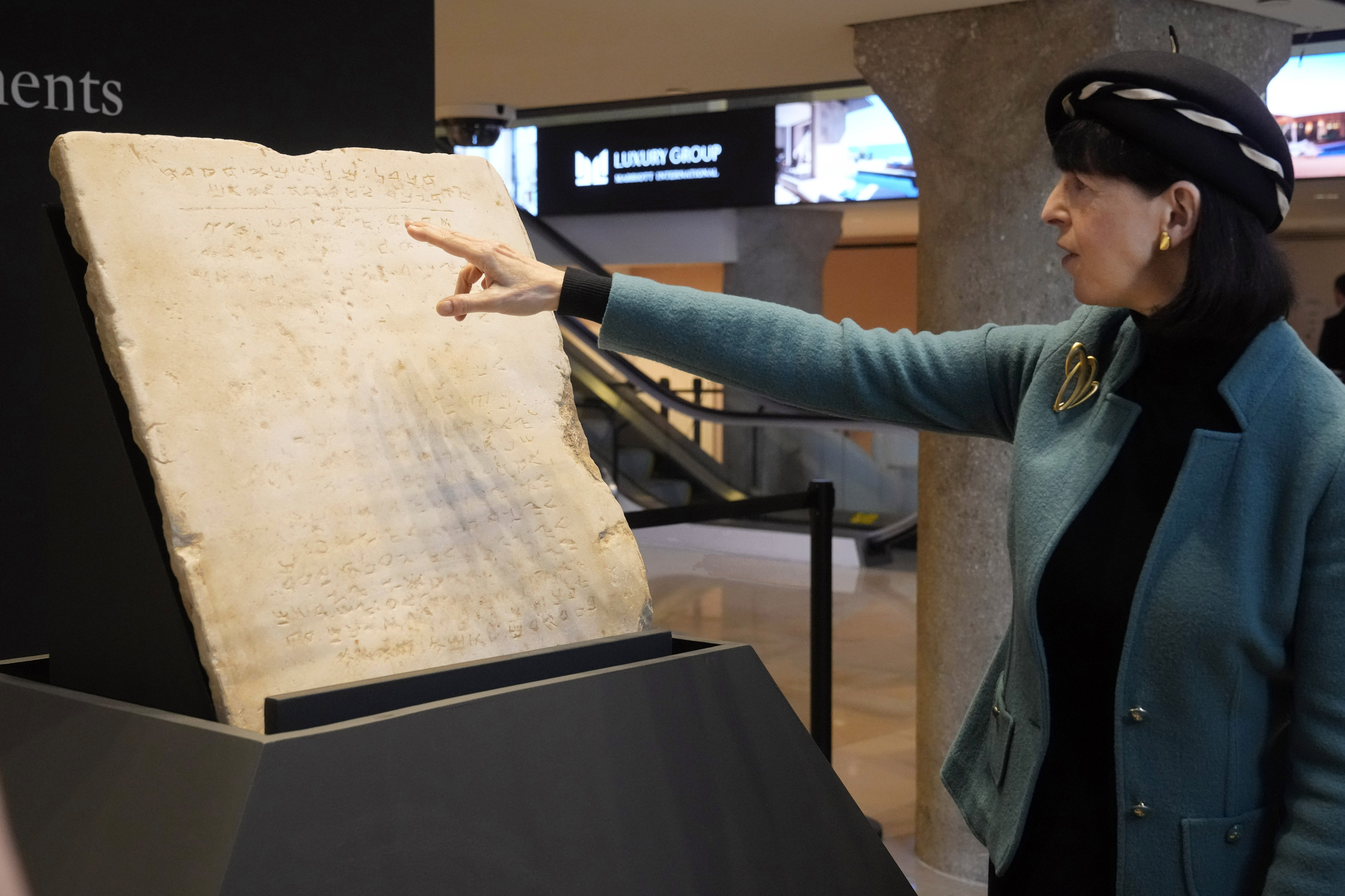 Sharon Liberman Mintz, Sotheby's Judaica Specialist, Books & Manuscripts, discusses the oldest complete tablet of the Ten Commandments, weighing 115-pounds and approximately 1,500 years old, that is displayed at Sotheby's, in New York, Monday, Dec. 9, 2024, where it is to be offered for auction in a single lot sale, Dec, 18, 2024. (AP Photo/Richard Drew)