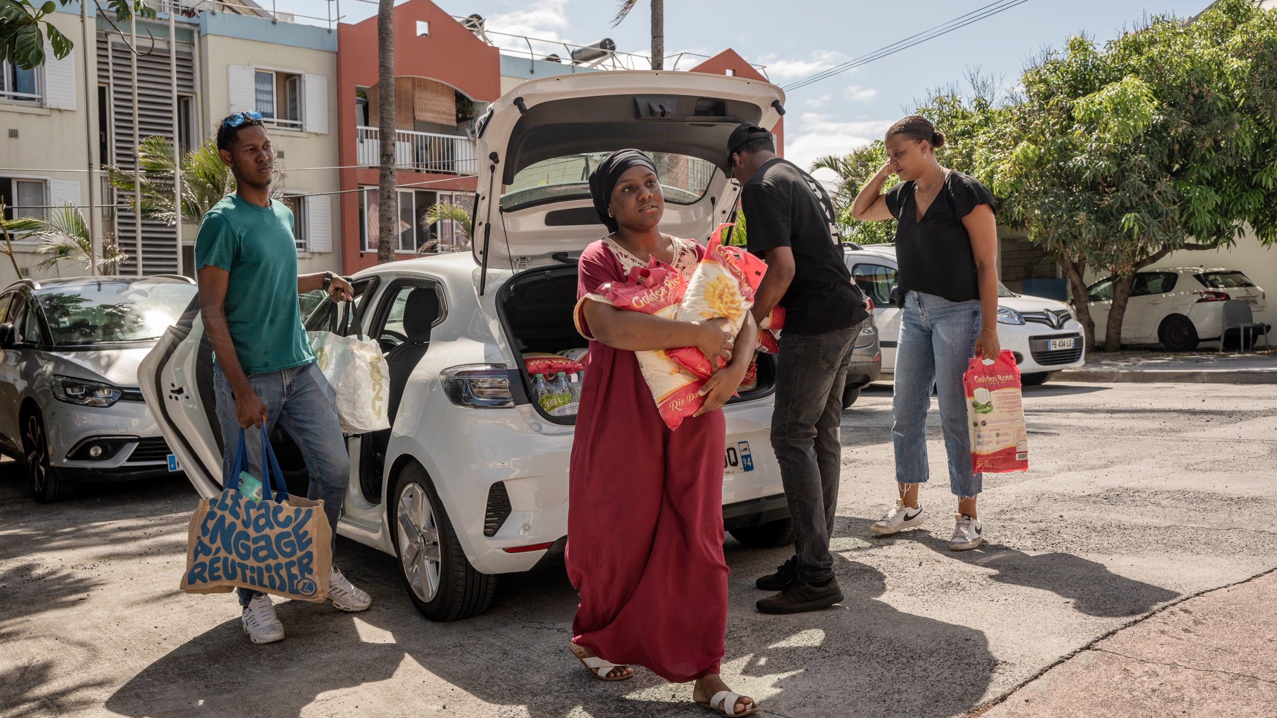 People bring goods for victims of cyclone Chido in Mayotte at the House of Mayotte, in Saint-Denis, Réunion Island, Wednesday, Dec. 18, 2024. (AP Photo/Adrienne Surprenant)