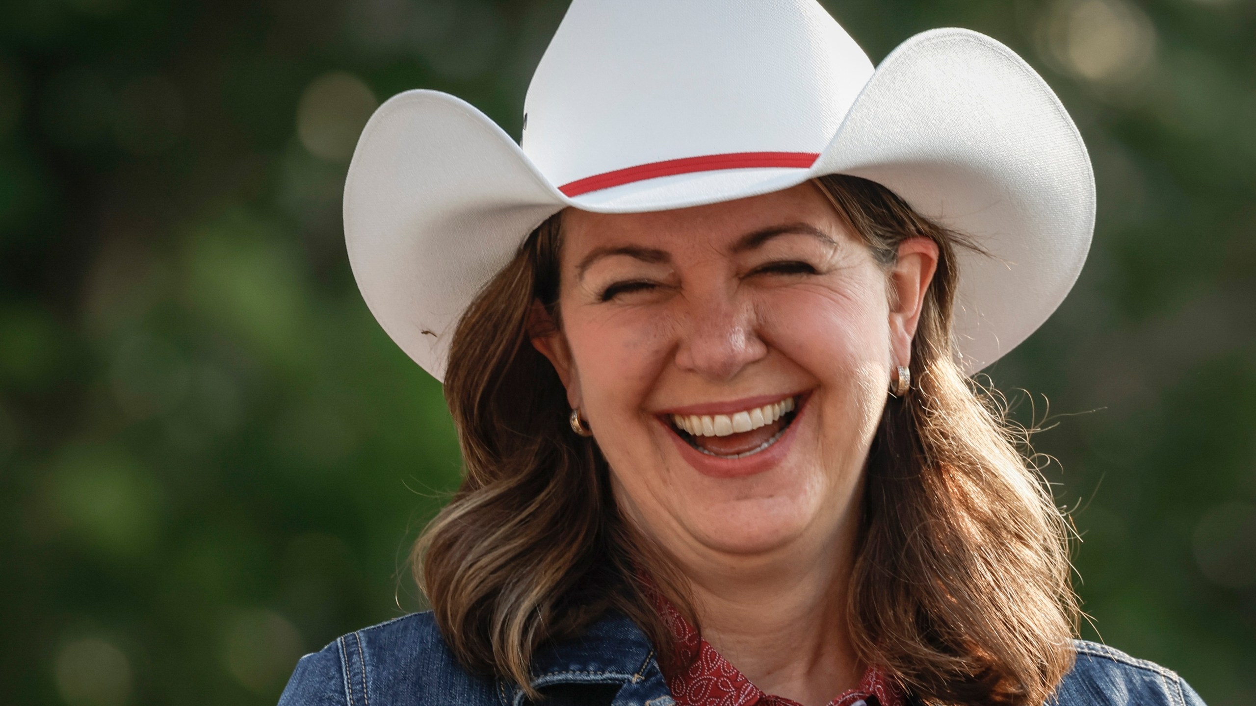 File - Alberta Premier Danielle Smith wears a cowboy hat during the Calgary Stampede parade in Calgary, Friday, July 7, 2023. (Jeff McIntosh /The Canadian Press via AP, File)