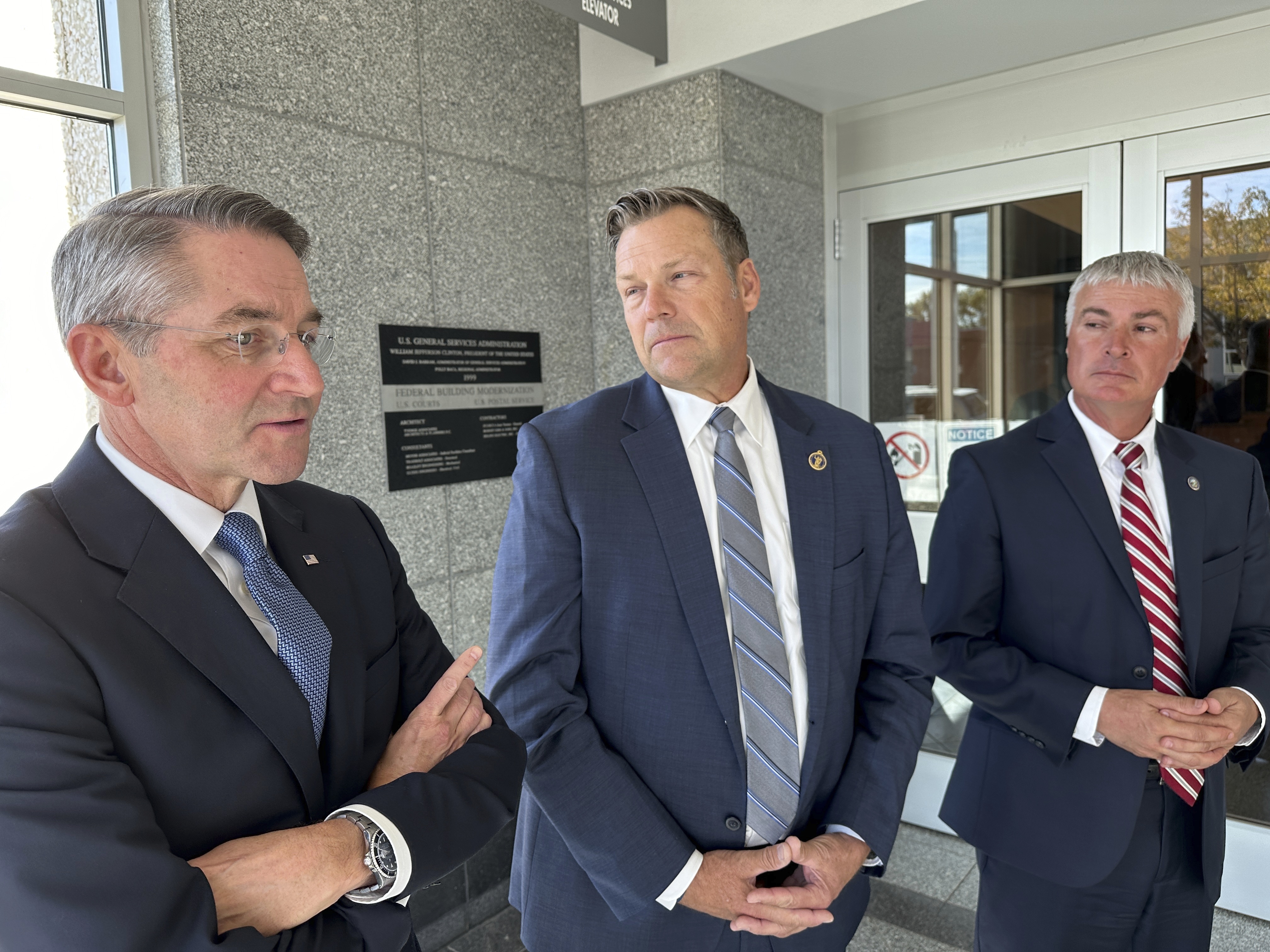 From left, Republican Attorneys General Drew Wrigley of North Dakota, Kris Kobach of Kansas and Marty Jackley of South Dakota speak to reporters after a hearing in federal court in Bismarck, N.D., on Tuesday, Oct. 15, 2024. (AP Photo/Jack Dura)