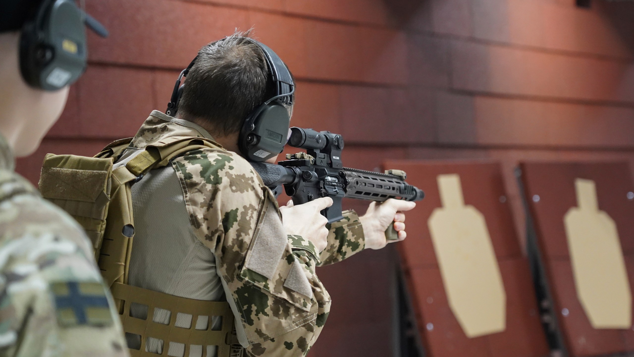 Members of the Vantaa Reservists Association practice at a shooting range in a warehouse in Kerava on the outskirts of Helsinki, Finland, Monday, Dec. 2, 2024. (AP Photo/James Brooks)