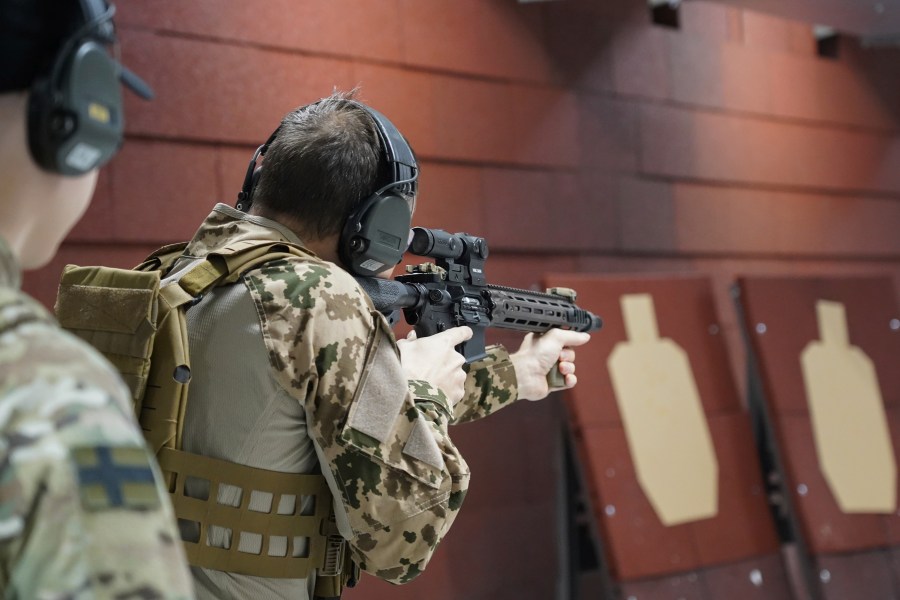 Members of the Vantaa Reservists Association practice at a shooting range in a warehouse in Kerava on the outskirts of Helsinki, Finland, Monday, Dec. 2, 2024. (AP Photo/James Brooks)