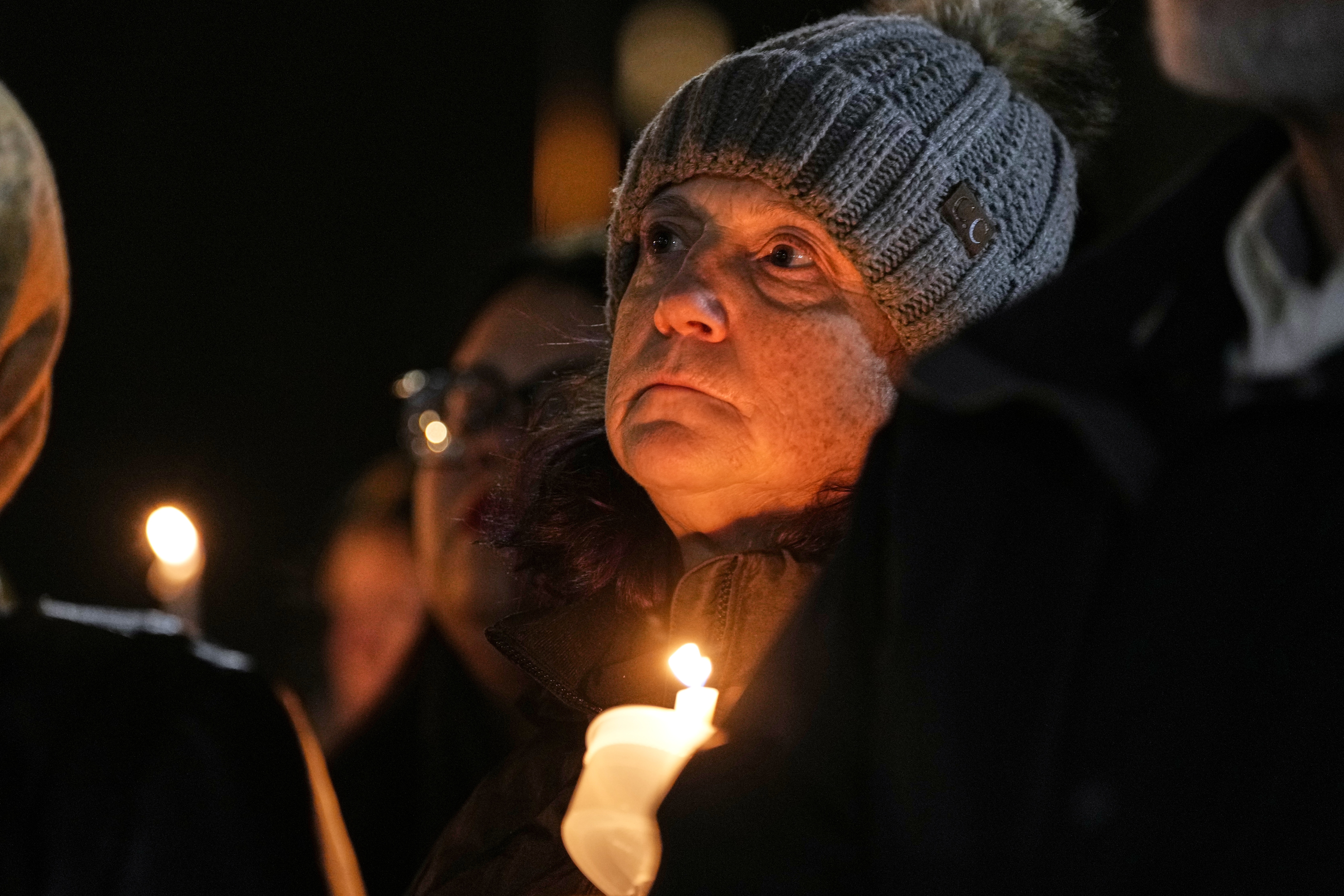 Supporters hold candles during a candlelight vigil Tuesday, Dec. 17, 2024, outside the Wisconsin Capitol in Madison, Wis., following a shooting at the Abundant Life Christian School on Monday, Dec. 16. (AP Photo/Morry Gash)