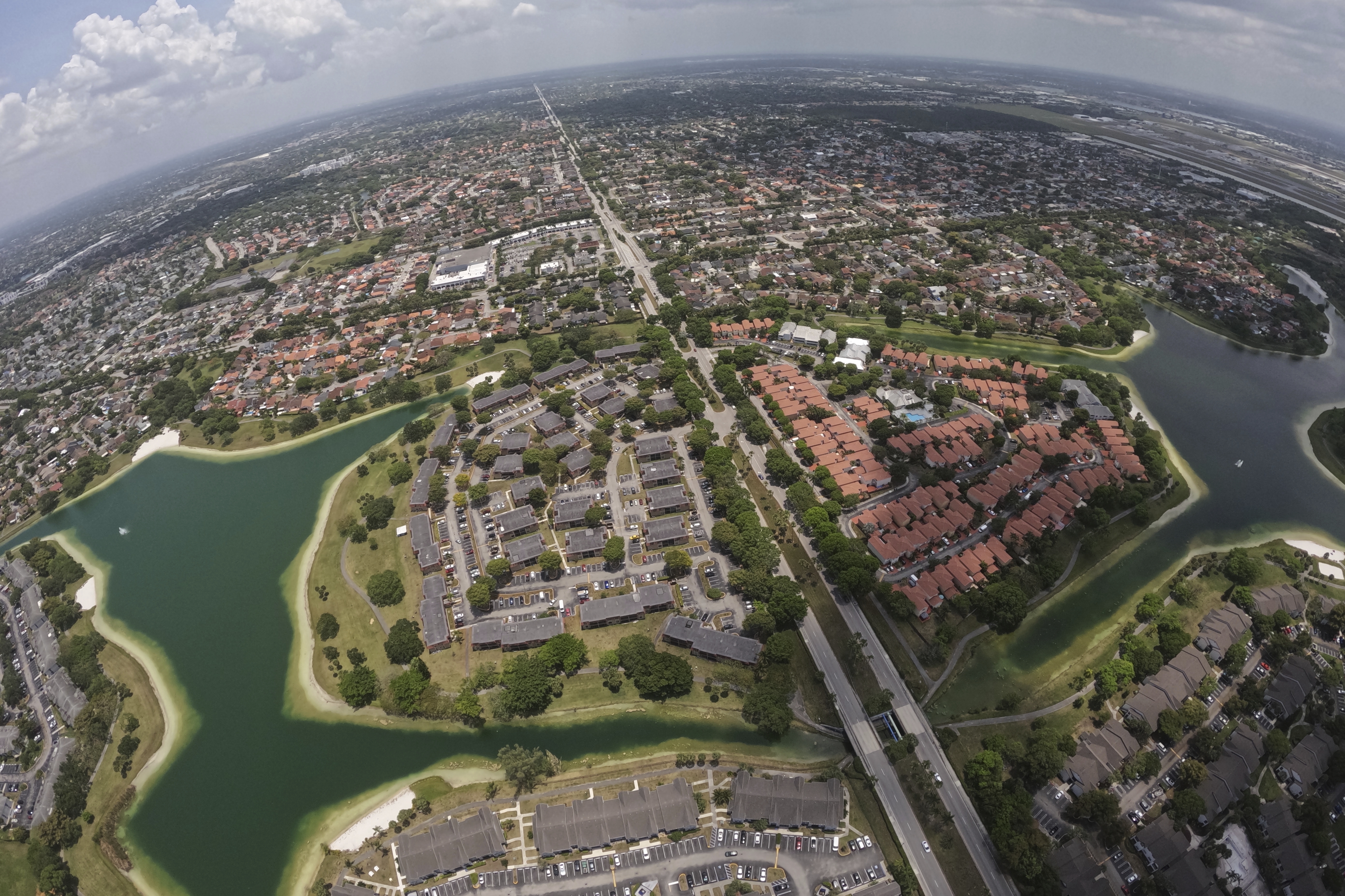 Housing developments are seen amid artificial lakes on the western side of Miami, Friday, May 17, 2024, during a flight donated by LightHawk over parts of the vast Everglades ecosystem in southern Florida. (AP Photo/Rebecca Blackwell)