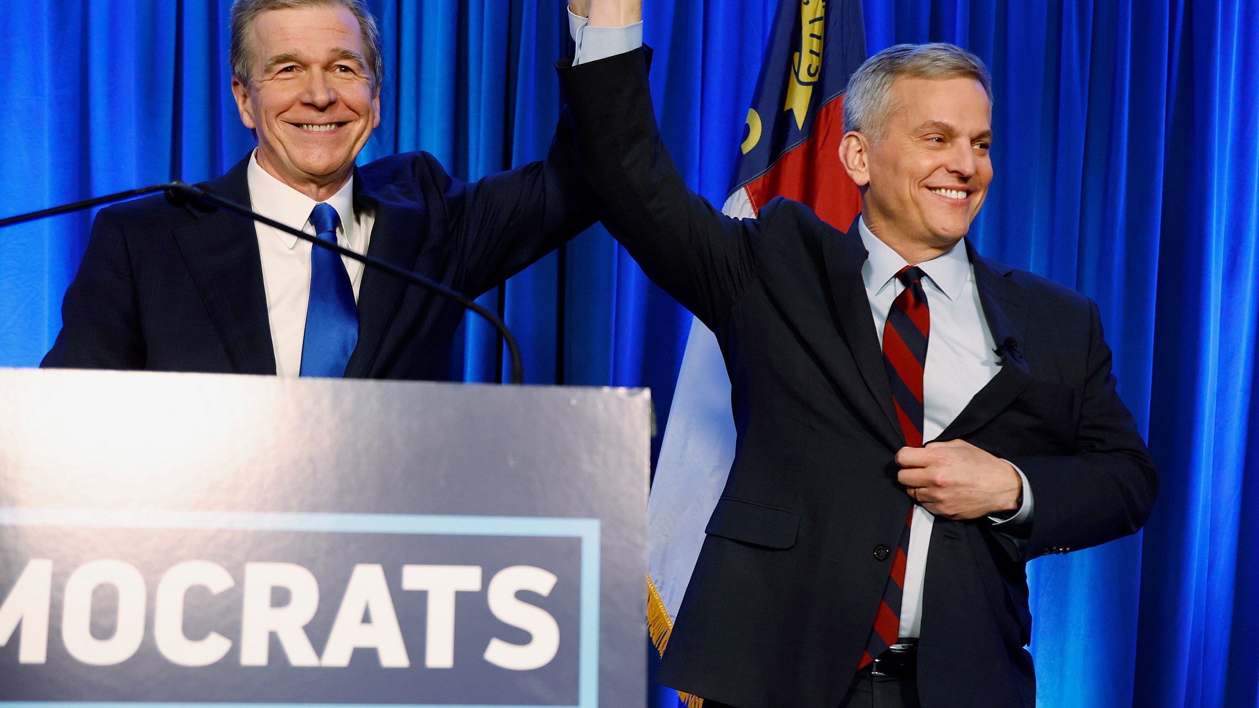 FILE - North Carolina's Democratic gubernatorial candidate Josh Stein, right, is introduced by North Carolina Gov. Roy Cooper at a primary election night party in Raleigh, N.C., March 5, 2024. (AP Photo/Karl B DeBlaker, File)