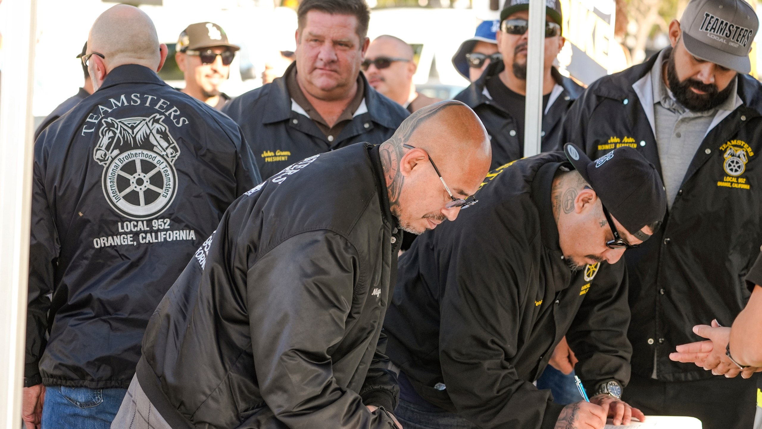 Teamsters Local 952 members sign-in as they join Amazon workers striking outside the gates of an Amazon Fulfillment Center, Thursday, Dec. 19, 2024, in City of Industry, Calif. (AP Photo/Damian Dovarganes)