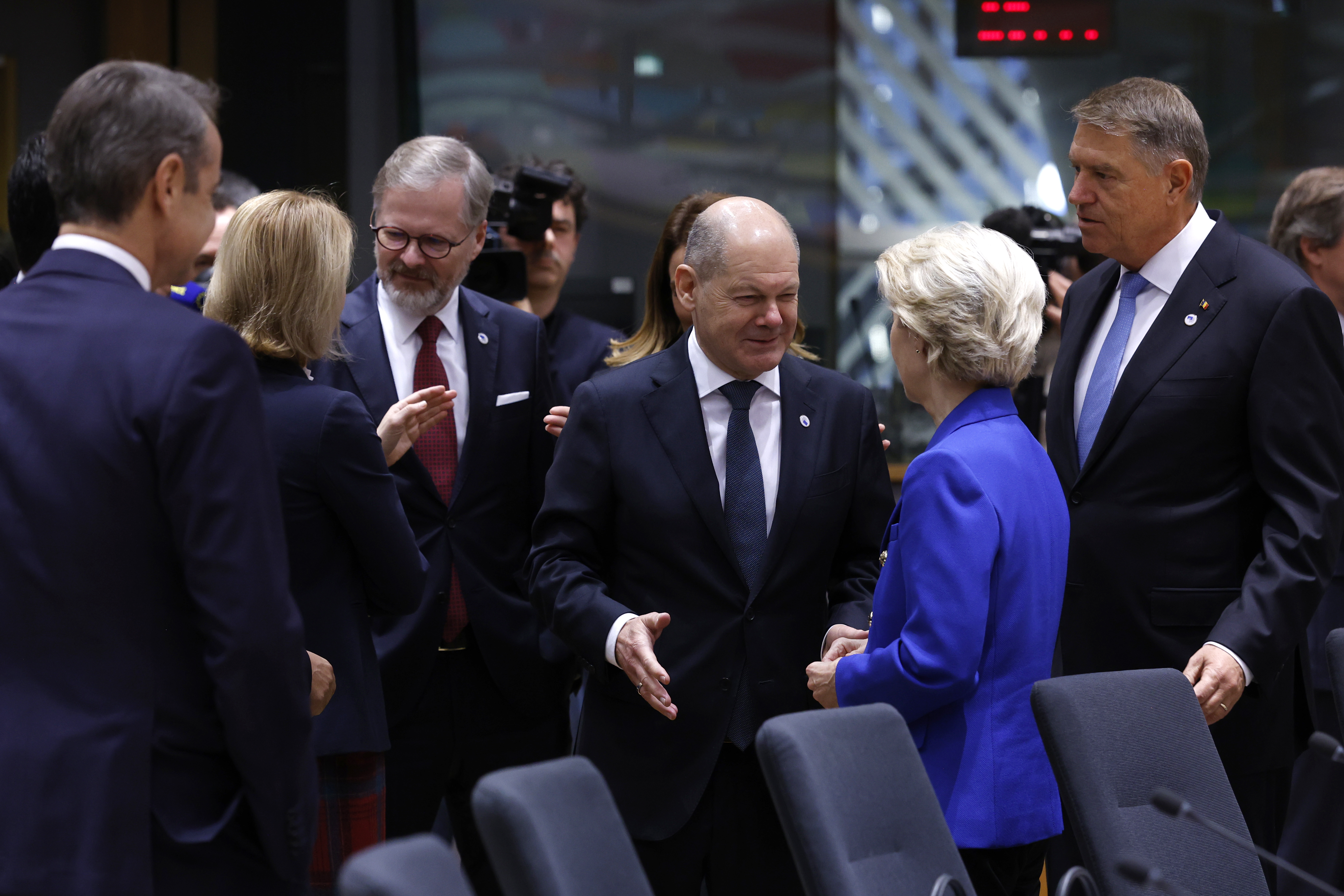 Germany's Chancellor Olaf Scholz, center, speaks with European Commission President Ursula von der Leyen during a round table meeting at an EU summit in Brussels, Thursday, Dec. 19, 2024. (AP Photo/Omar Havana)