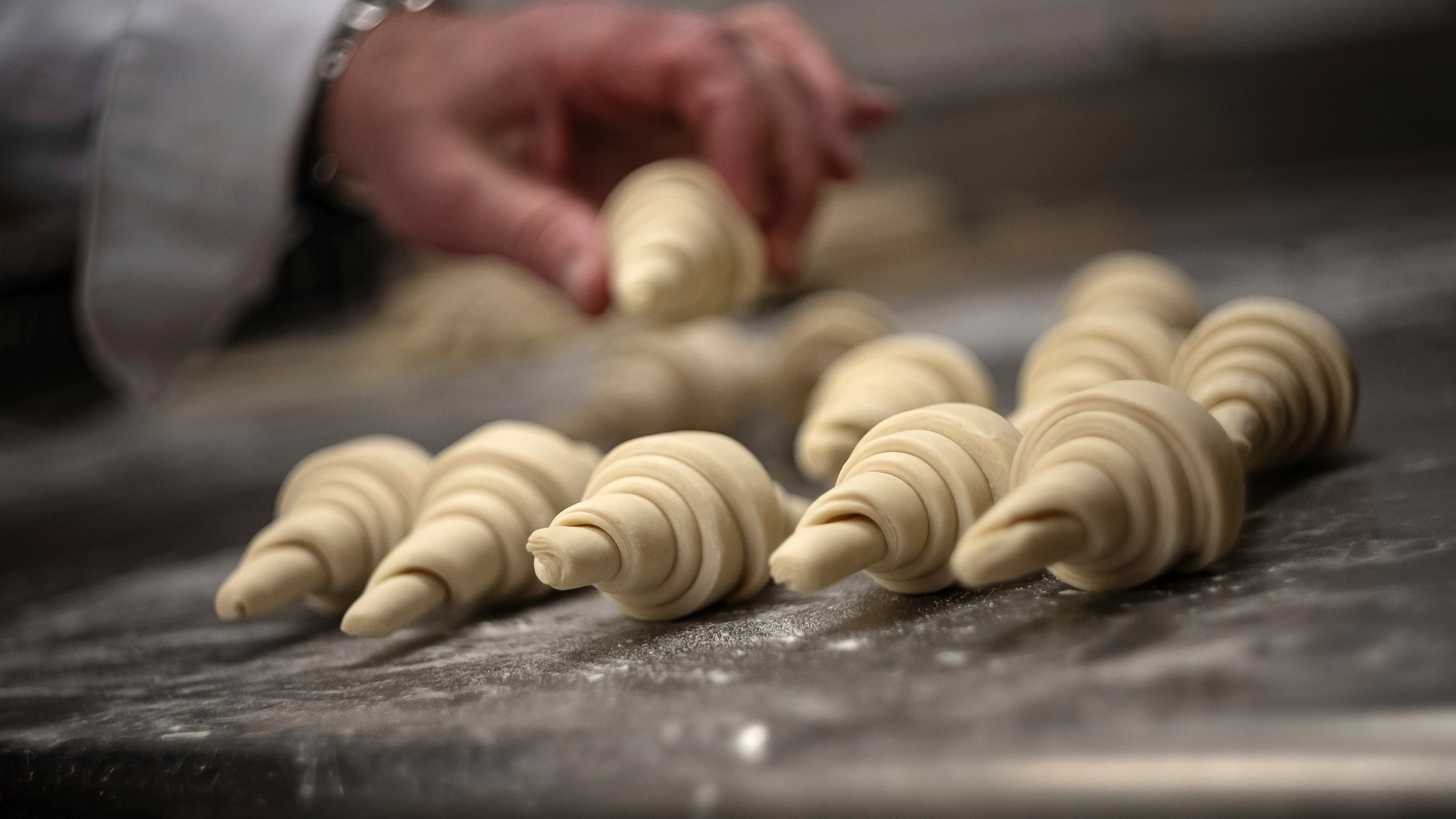 French baker Arnaud Delmontel bakes butter croissants in Paris, Monday, Dec. 16, 2024 as butter has shot up in price across Europe in recent months, adding more pain to consumers this holiday season after years of inflation in the wake of the COVID-19 pandemic and war in Ukraine.(AP Photo/Aurelien Morissard)