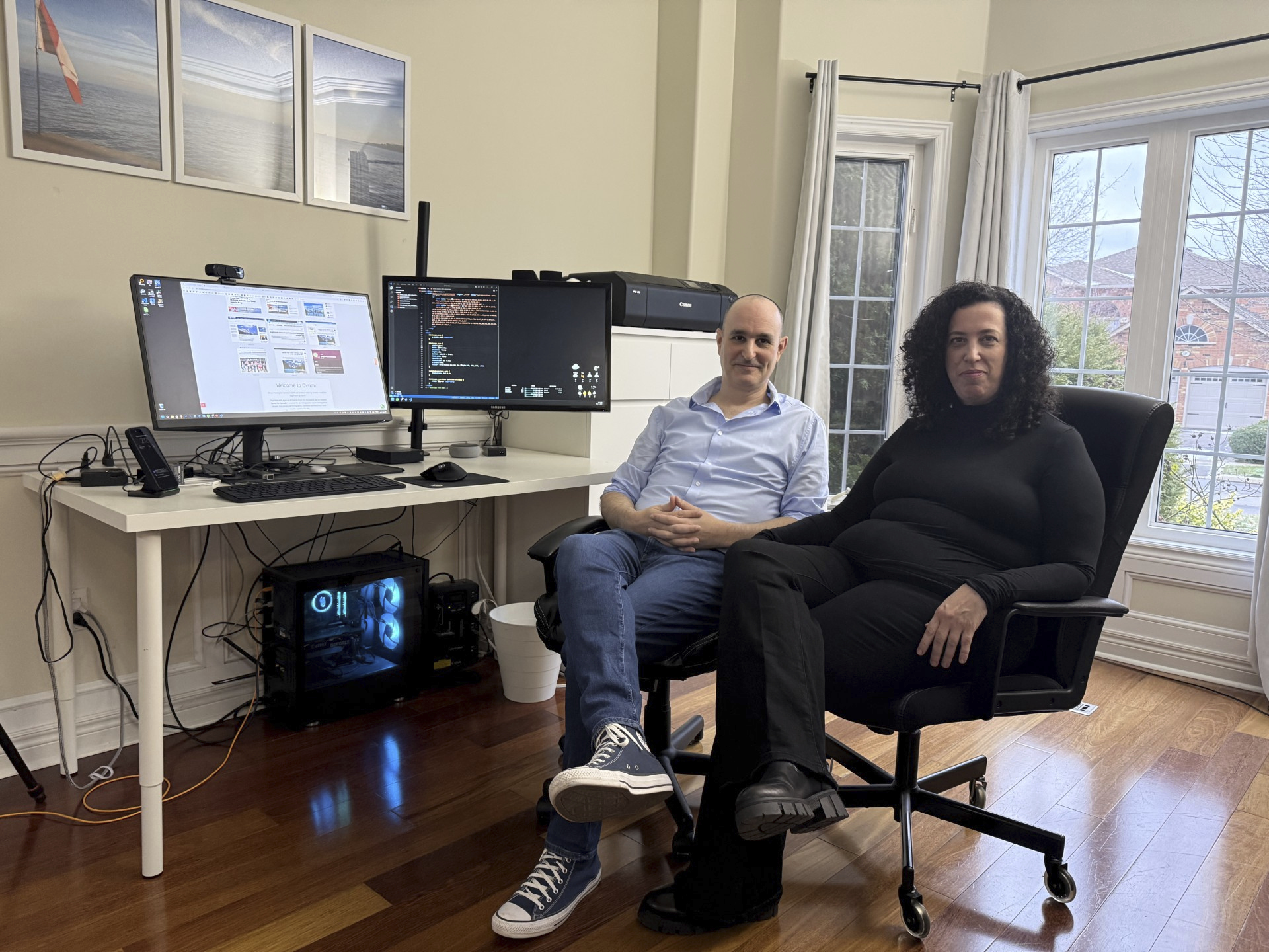 Michal Harel and her husband Avital Epstein show the website they set up to help Israelis navigate a move to Canada in Oakville, Ontario, Canada, Wednesday, Dec. 4, 2024. (AP Photo/Rob Gillies)