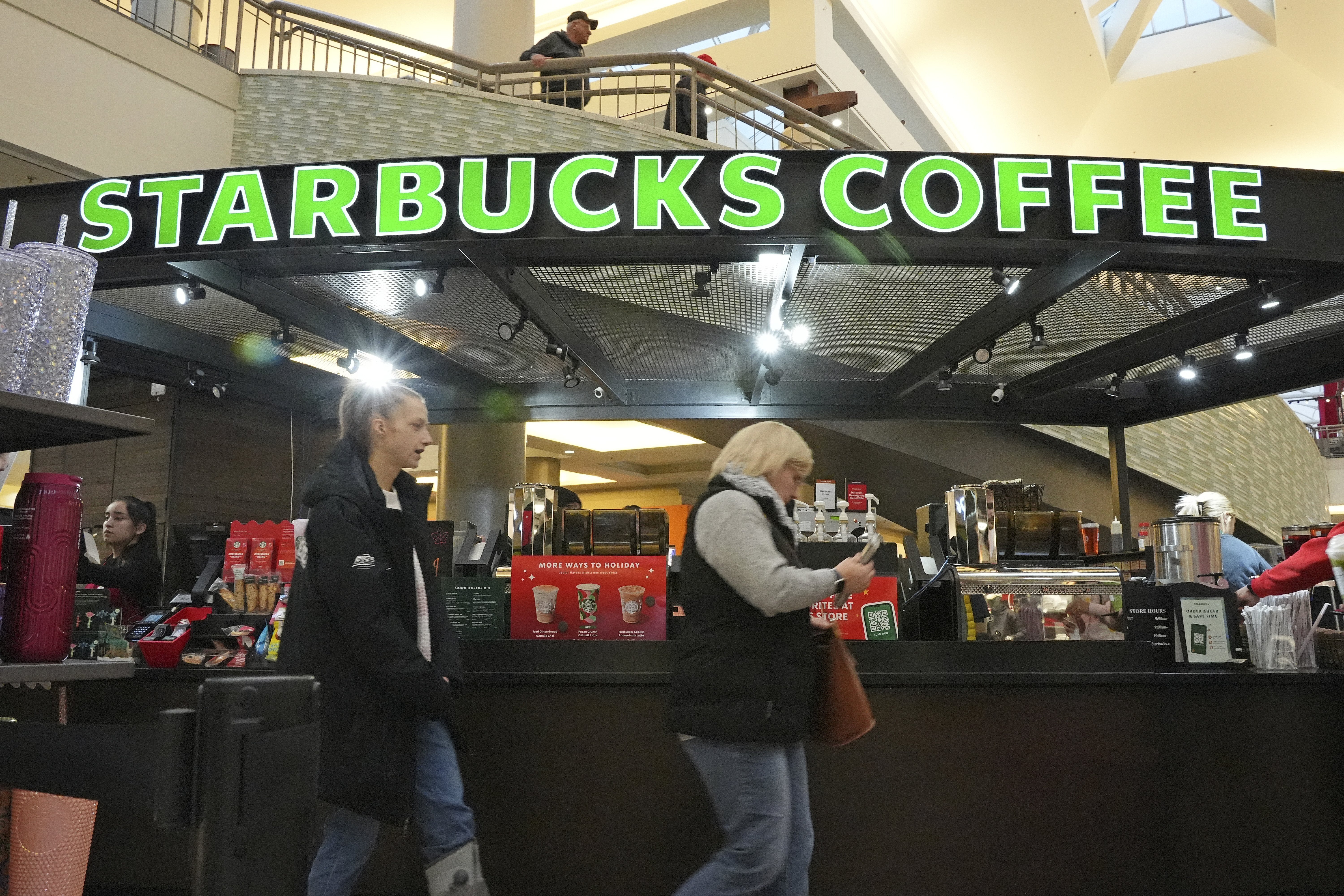 FILE - Shoppers at the Walden Galleria in Buffalo, NY, stop by the Starbucks kiosk on Nov. 30, 2024. (AP Photo/Gene J. Puskar, File)