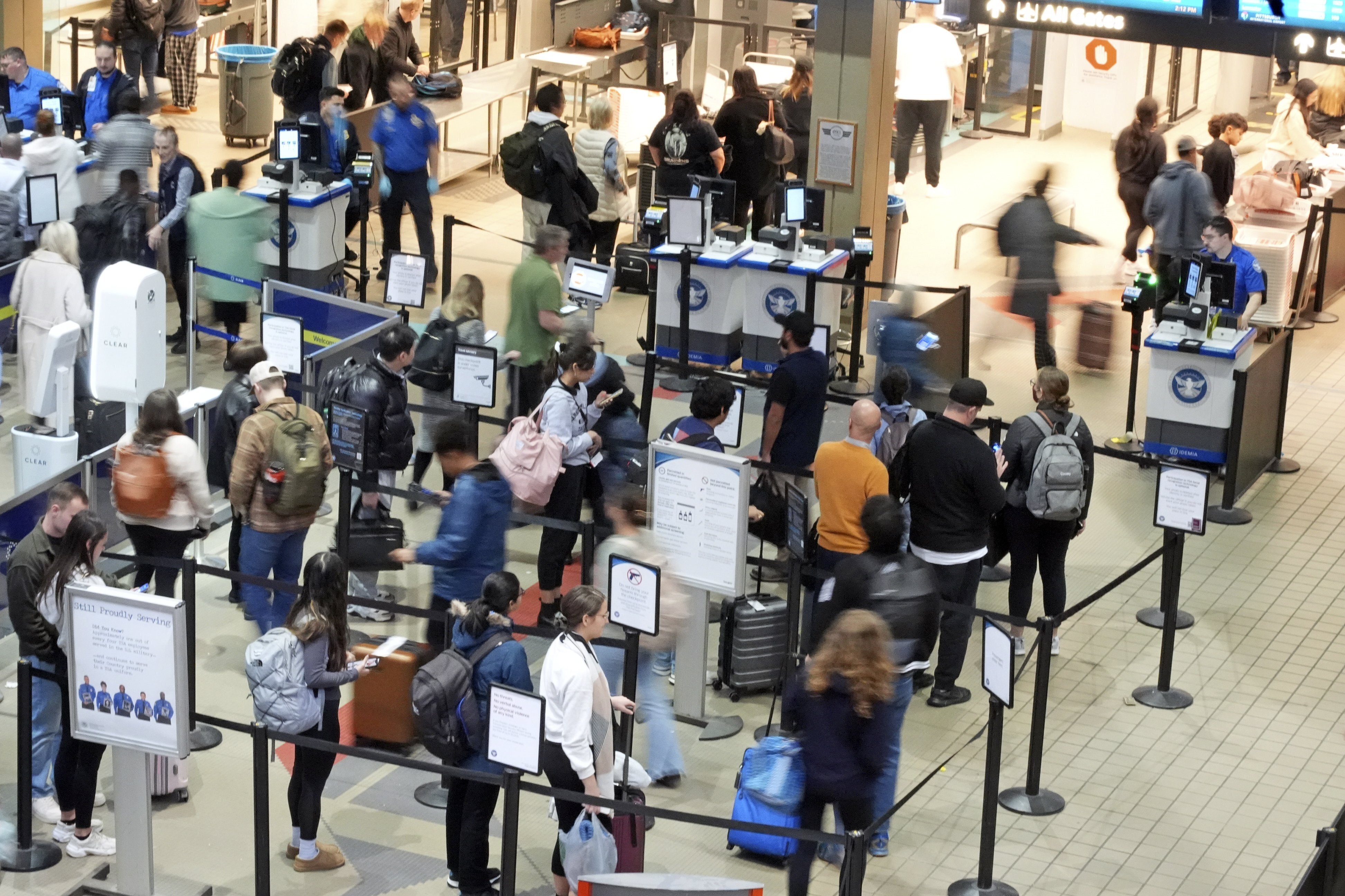 FILE - Passengers line up at the security checkpoint in Pittsburgh International Airport Dec. 11, 2024. (AP Photo/Gene J. Puskar, File)