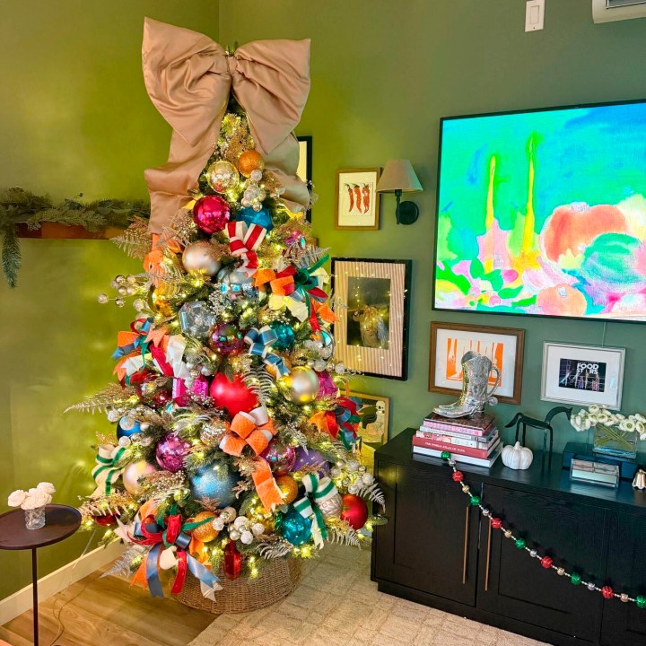 This undated photo provided by Jess Druey shows a skinny artificial tree bought at Target that Druey decorated with retro big holiday ornament balls in primary colors in reds and blues. (Jess Druey via AP)