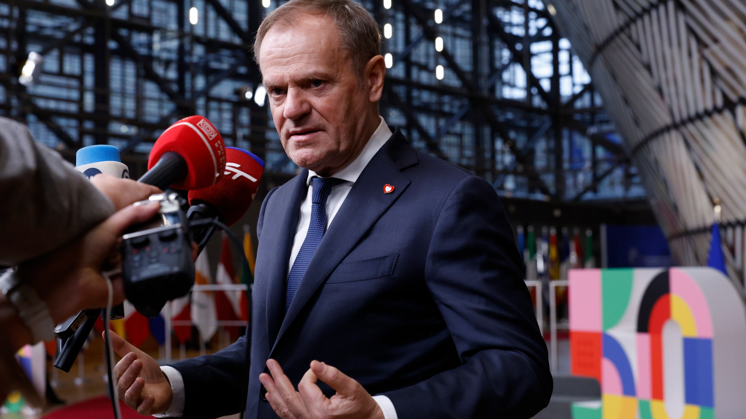 Poland's Prime Minister Donald Tusk speaks with the media prior to a group photo at an EU summit in Brussels, Thursday, Dec. 19, 2024. (AP Photo/Omar Havana)