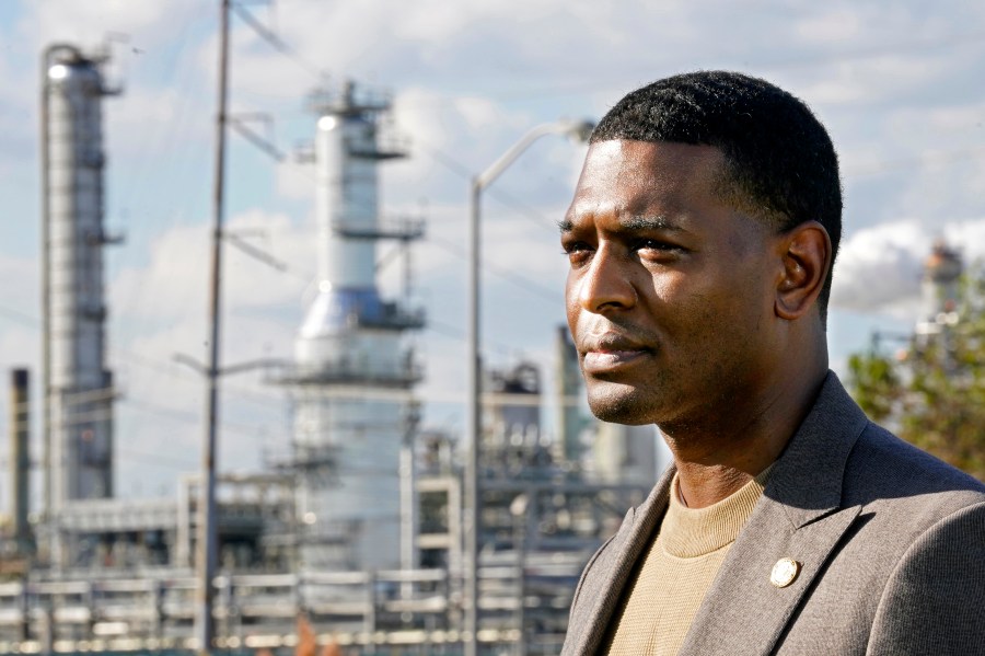 FILE - EPA Administrator Michael Regan stands near the Marathon Petroleum Refinery as he conducts a television interview, while touring neighborhoods that abut the refinery, in Reserve, La., Nov. 16, 2021. (AP Photo/Gerald Herbert, File)