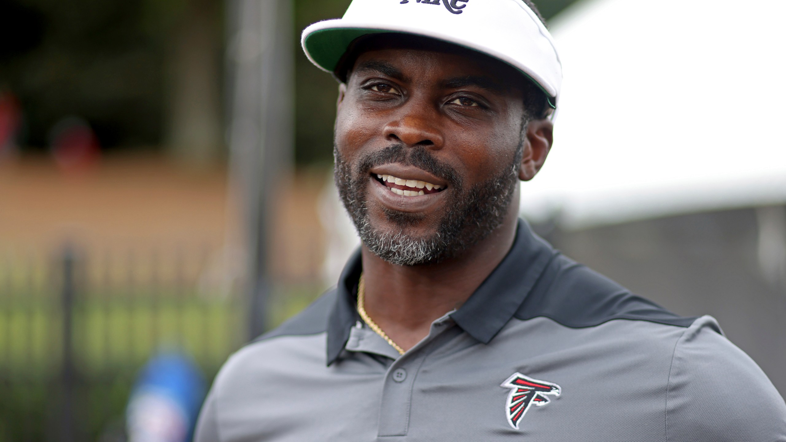 FILE - Former Atlanta Falcons quarterback Michael Vick speaks to members of the media during NFL football training camp at the team's practice facility in Flowery Branch, Ga., Wednesday, Aug. 10, 2022. (Jason Getz/Atlanta Journal-Constitution via AP, File)/Atlanta Journal-Constitution via AP)