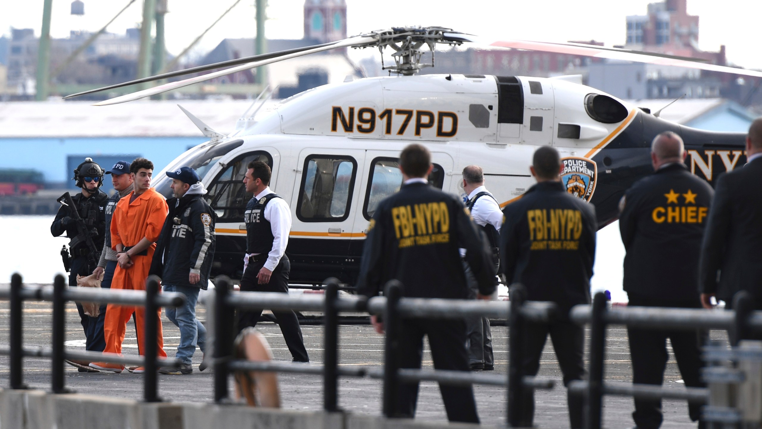 Luigi Mangione, a suspect in the fatal shooting of UnitedHealthcare CEO Brian Thompson, is escorted off of a helicopter by police, Thursday, Dec. 19, 2024, in New York. (AP Photo/Pamela Smith)