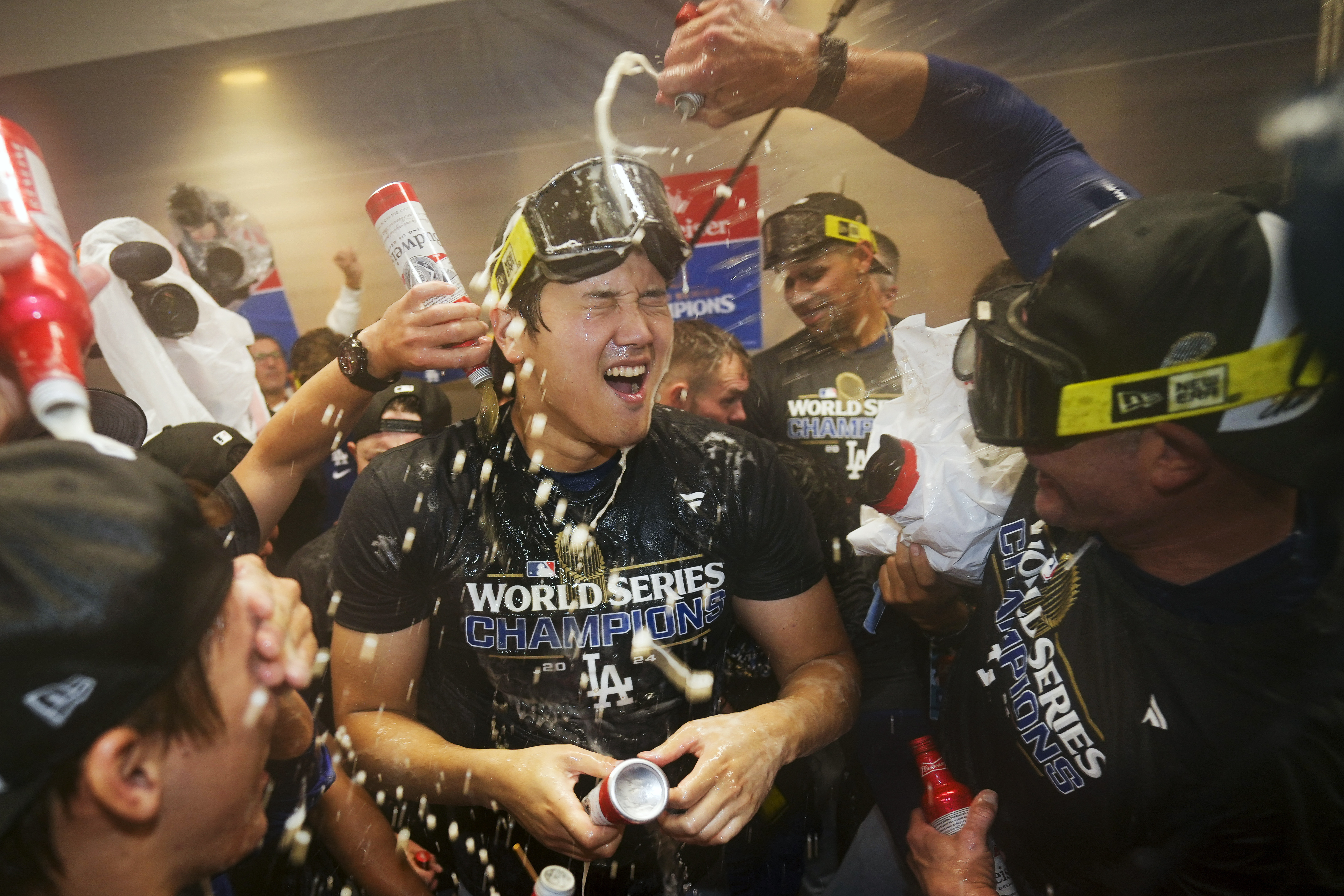 FILE- Los Angeles Dodgers' Shohei Ohtani celebrates in the locker room after their win against the New York Yankees in Game 5 to win the baseball World Series, Thursday, Oct. 31, 2024, in New York. (AP Photo/Ashley Landis, File)