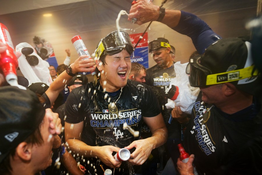 FILE- Los Angeles Dodgers' Shohei Ohtani celebrates in the locker room after their win against the New York Yankees in Game 5 to win the baseball World Series, Thursday, Oct. 31, 2024, in New York. (AP Photo/Ashley Landis, File)