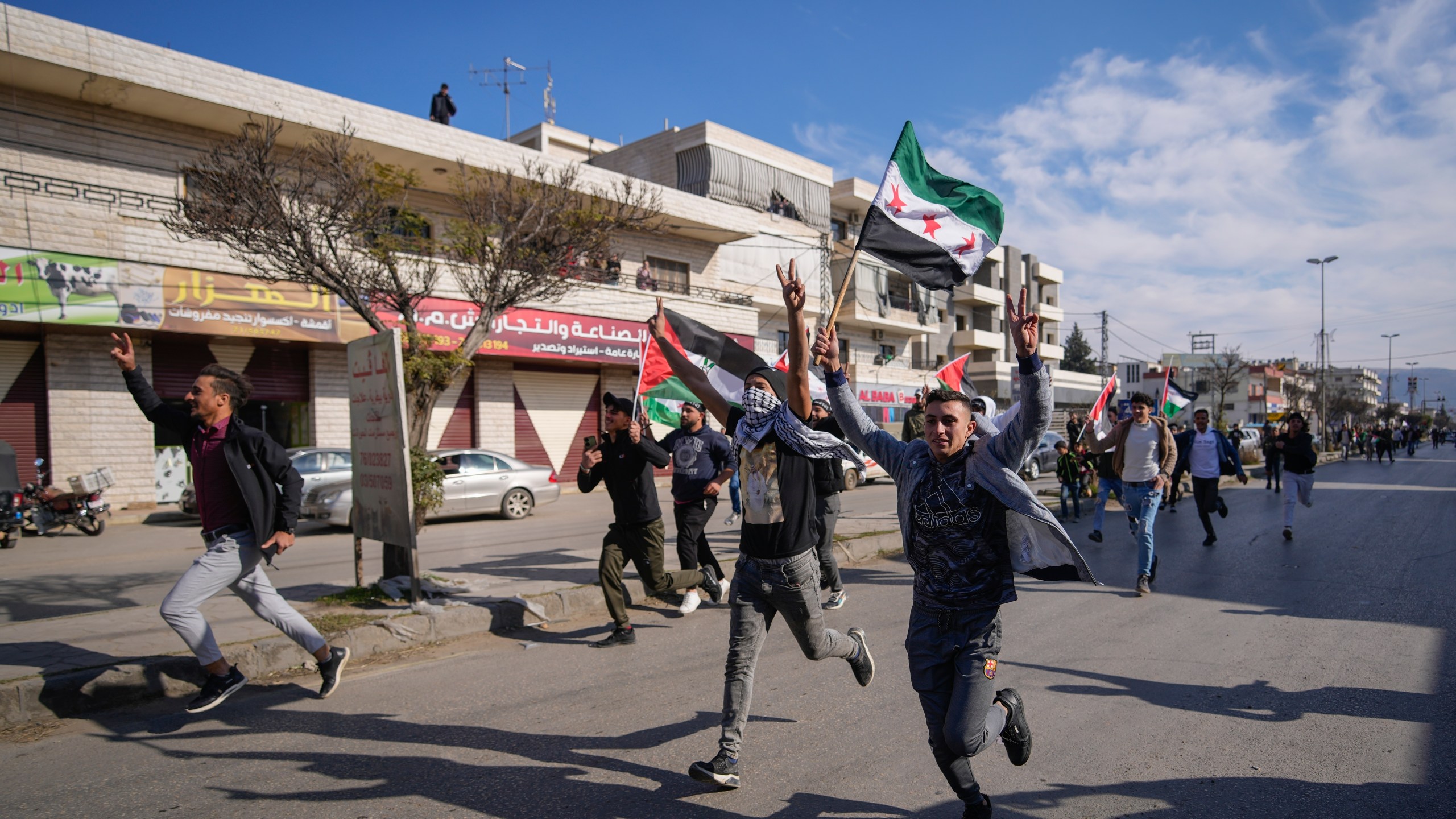 FILE - Syrians celebrate the fall of Bashar Assad's government in the town of Bar Elias, Lebanon, near the border with Syria, Sunday, Dec. 8, 2024. (AP Photo/Hassan Ammar, File)