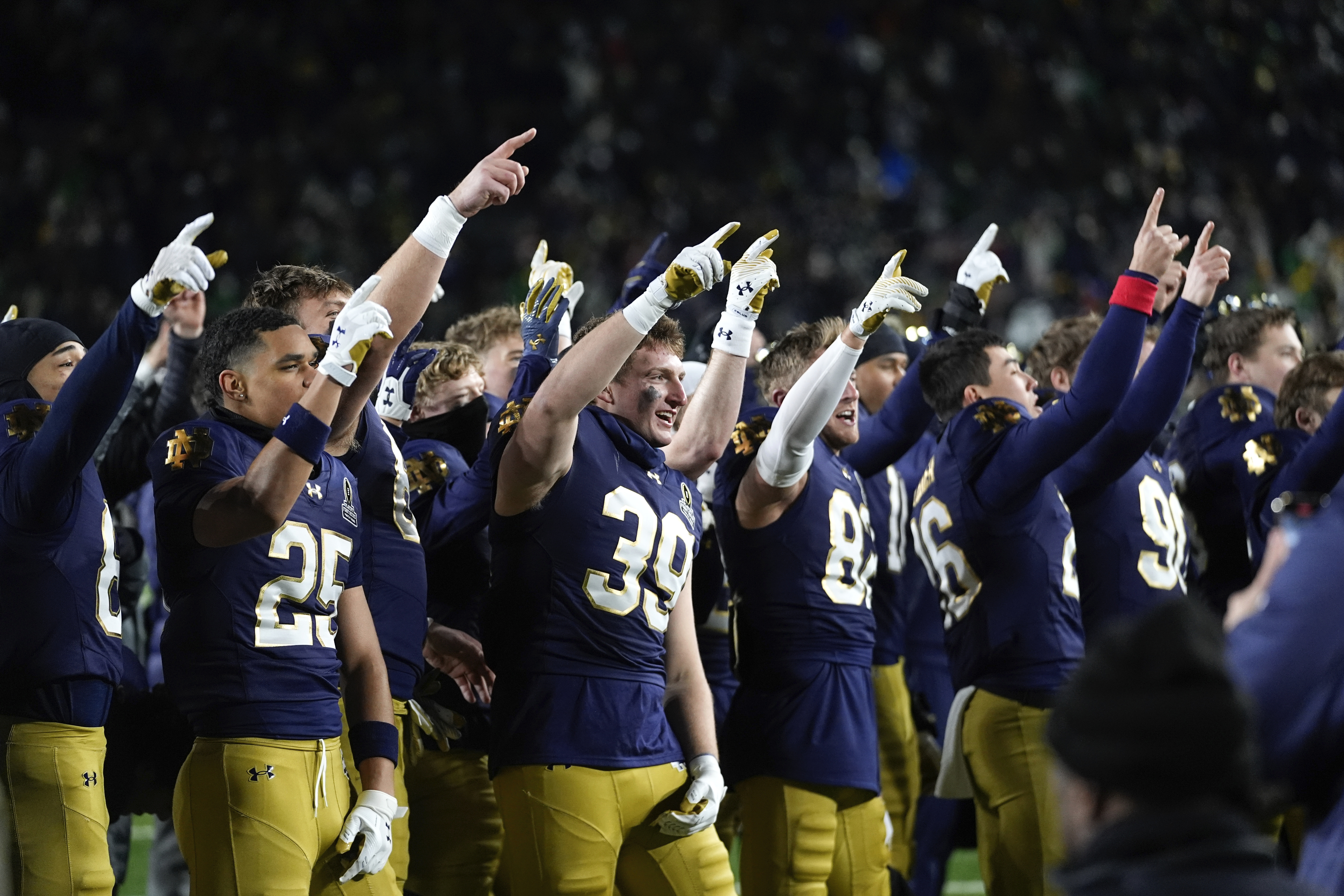 Notre Dame players celebrate after beating Indiana 27-17 in the first round of the NCAA College Football Playoff, Friday, Dec. 20, 2024, in South Bend, Ind. (AP Photo/Darron Cummings)