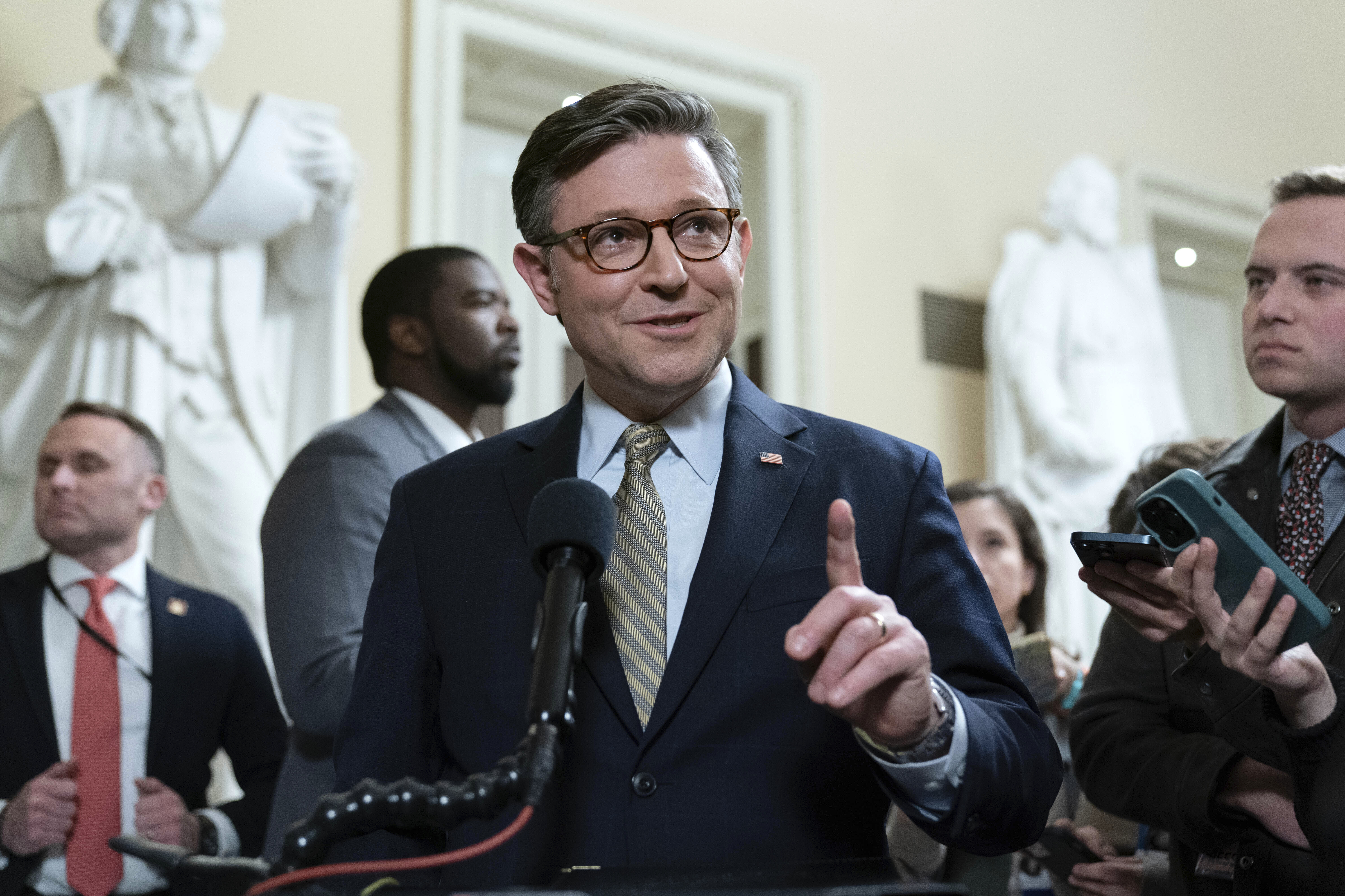 Speaker of the House Mike Johnson, R-La., talks to reporters after passing the funding bill to avert the government shutdown at the Capitol in Washington, Friday, Dec. 20, 2024. (AP Photo/Jose Luis Magana)