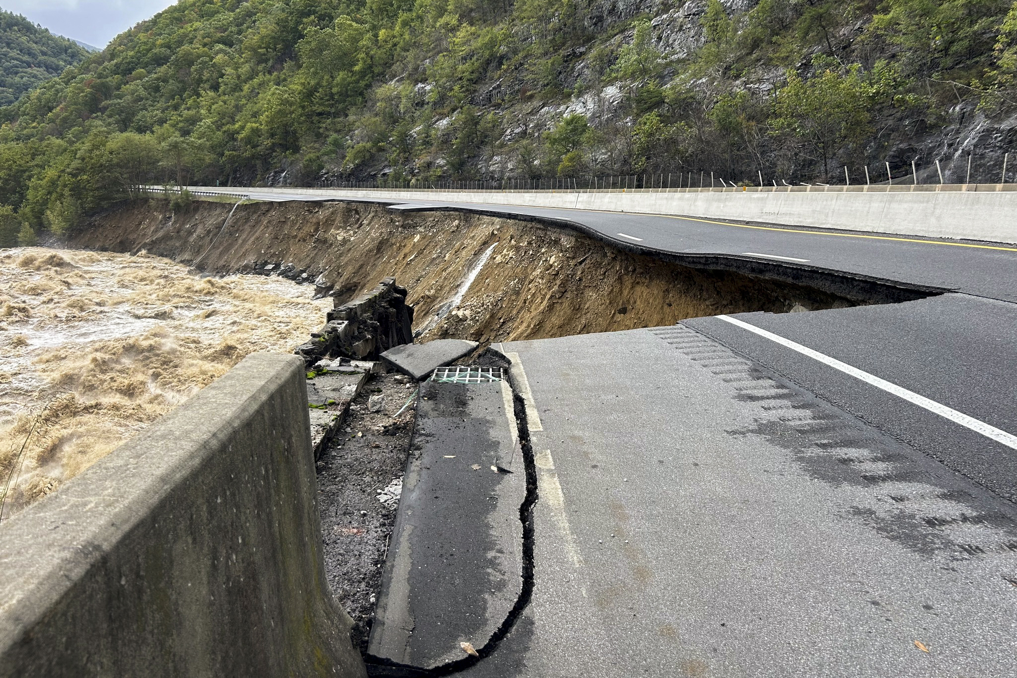 FILE - This photo provided by the North Carolina Department of Transportation shows the collapsed eastbound lane of I-40 into the Pigeon River in North Carolina near the Tennessee border, Sept. 28, 2024. (N.C. Department of Transportation via AP, File)