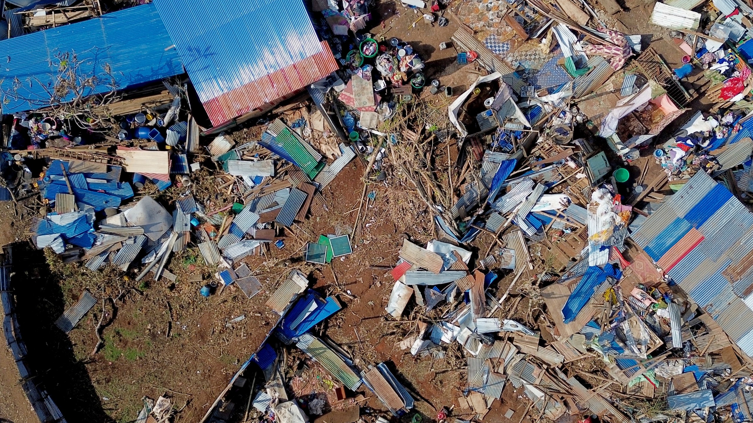 This aerial view shows destroyed homes in the Barakani, Mayotte, informal settlement, Saturday, Dec. 21, 2024. (AP Photo/Adrienne Surprenant)