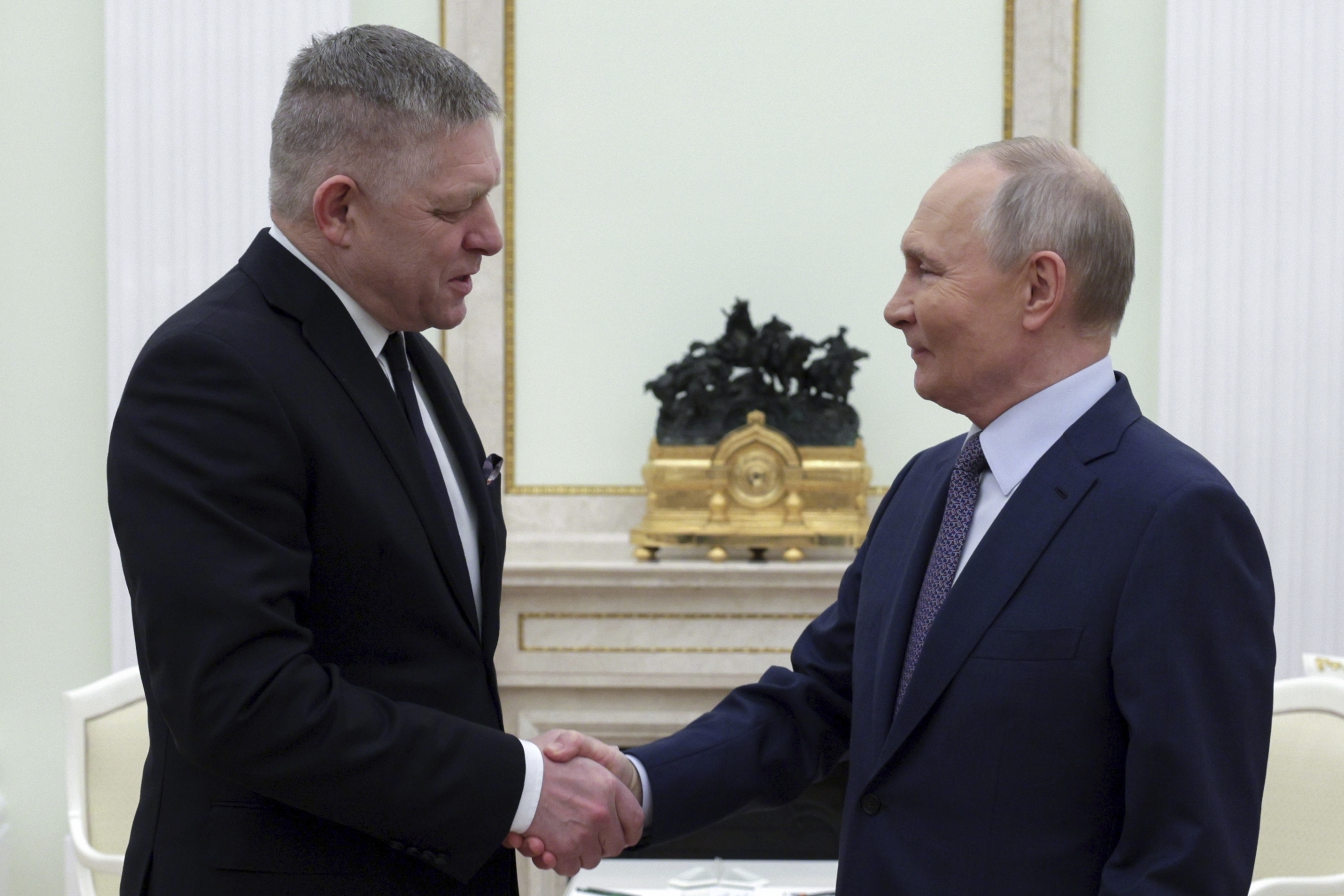 Russian President Vladimir Putin, right, and Slovak Prime Minister Robert Fico shake hands during their meeting at the Kremlin in Moscow, Russia, Sunday, Dec. 22, 2024. (Gavriil Grigorov, Sputnik, Kremlin Pool Photo via AP)