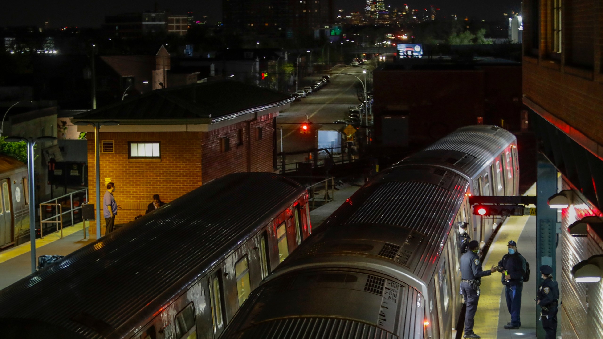 FILE - New York Police officers clear a train at the Coney Island Stillwell Avenue Terminal, May 5, 2020, in the Brooklyn borough of New York. (AP Photo/Frank Franklin II, file)