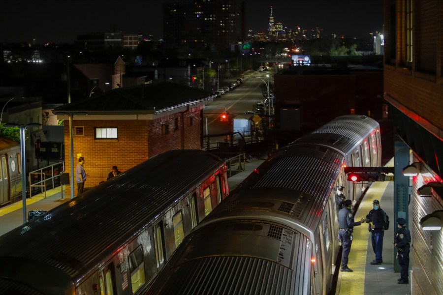 FILE - New York Police officers clear a train at the Coney Island Stillwell Avenue Terminal, May 5, 2020, in the Brooklyn borough of New York. (AP Photo/Frank Franklin II, file)