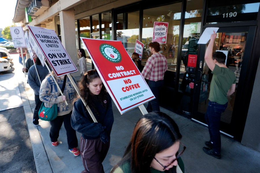 Starbuck workers picket outside of a closed Starbucks on Friday, Dec. 20, 2024, in Burbank, Calif. (AP Photo/Damian Dovarganes)