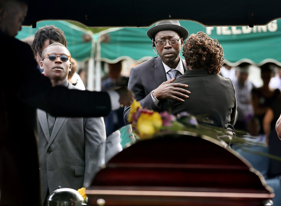 FILE - Tyrone Sanders and Felicia Sanders comfort each other at the graveside of their son, Tywanza Sanders, on June 27, 2015, at Emanuel AME Cemetery in Charleston, S.C. (Grace Beahm/The Post And Courier via AP, File)