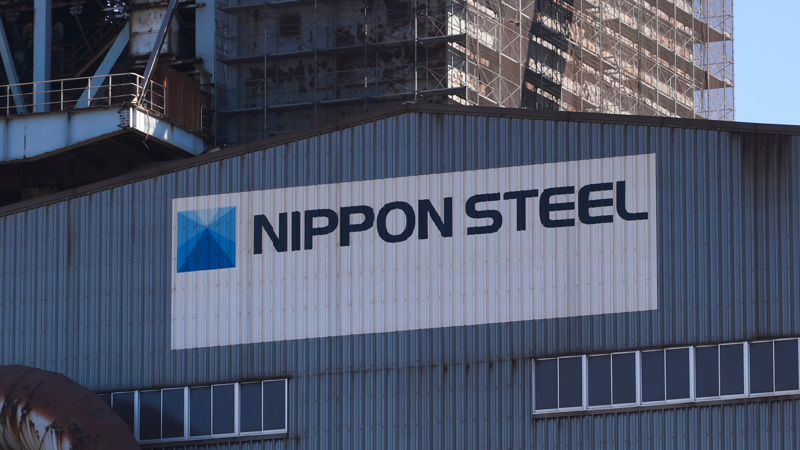 Logo of Nippon Steel on the exterior of Blast Furnace No. 1 at the company's Kashima Plant in Kashima, Japan on Friday, Dec. 6, 2024. (AP Photo/Ayaka McGill)