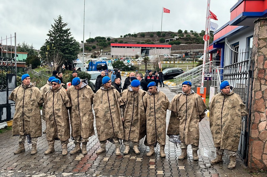 Turkish security forces stand guard next to parked ambulances at the entrance of an armament factory following an explosion that killed several people, in Balikesir, northwest Turkey, Tuesday, Dec. 24, 2024. (IHA via AP)