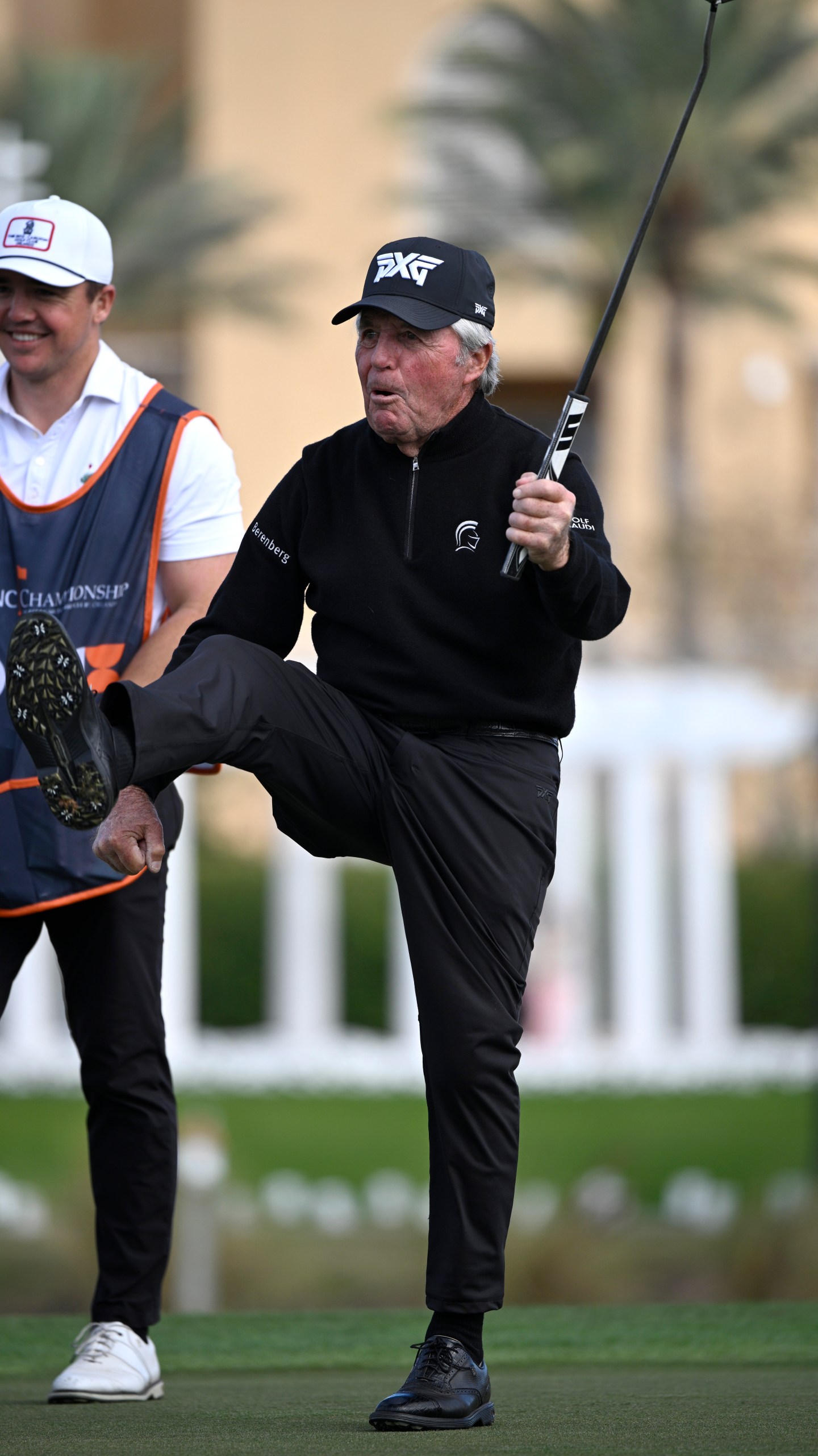 Gary Player, right, celebrates after making a putt on the 18th green as his son Wayne Player looks on during the final round of the PNC Championship golf tournament, Sunday, Dec. 22, 2024, in Orlando, Fla. (AP Photo/Phelan M. Ebenhack)