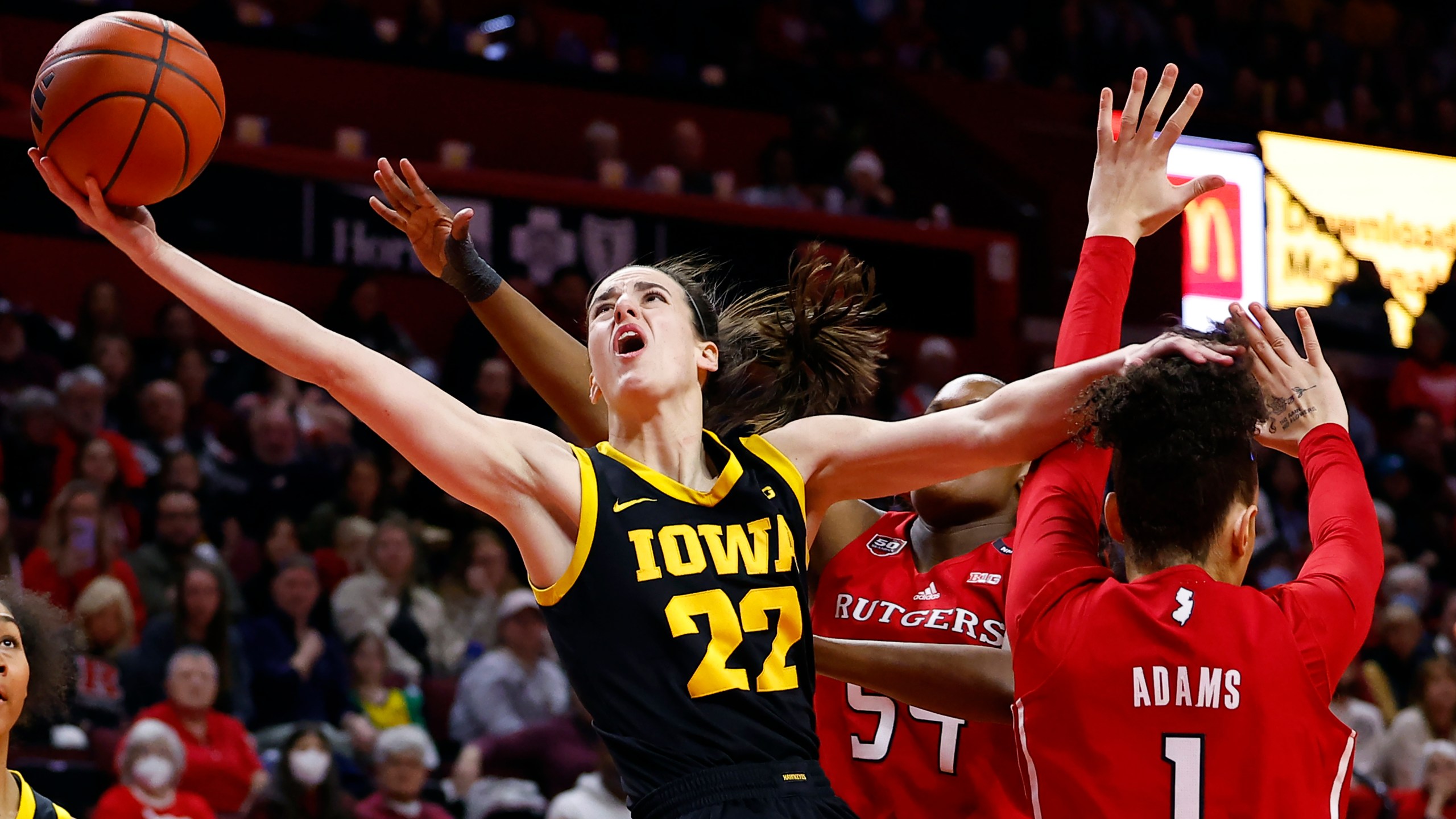 FILE - Iowa guard Caitlin Clark (22) drives to the basket past Rutgers guard Destiny Adams (1) during the first half of an NCAA college basketball game Friday, Jan. 5, 2024, in Piscataway, N.J. (AP Photo/Noah K. Murray, File)