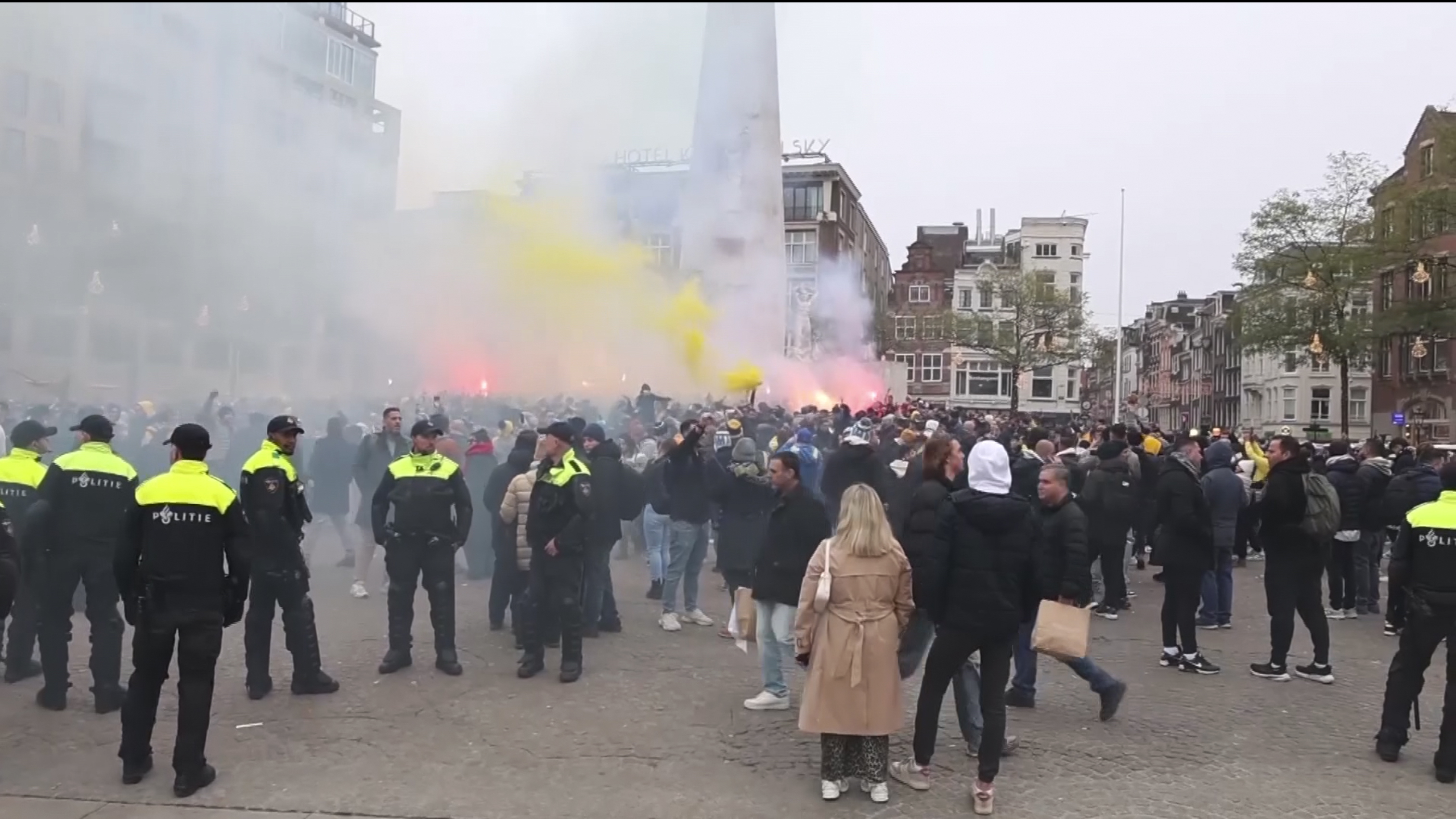 FILE - In this image taken from video, police stand guard as Maccabi Tel Aviv supporters light flares at the Dam square, in Amsterdam, the Netherlands, Thursday, Nov. 7, 2024. (AP Photo InterVision, File)